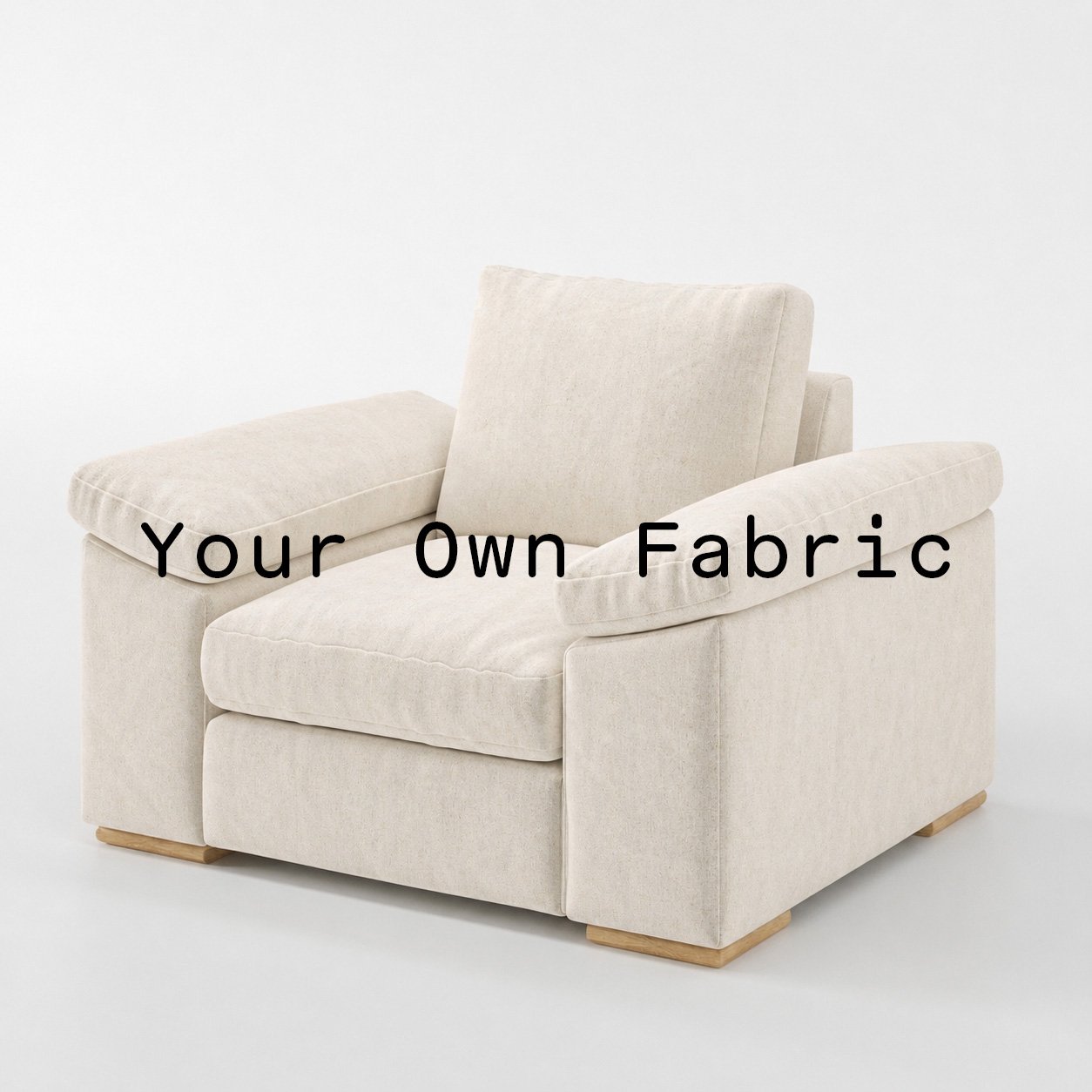 Diagonal view of the Moy armchair upholstered in customers own material calico cotton fabric.