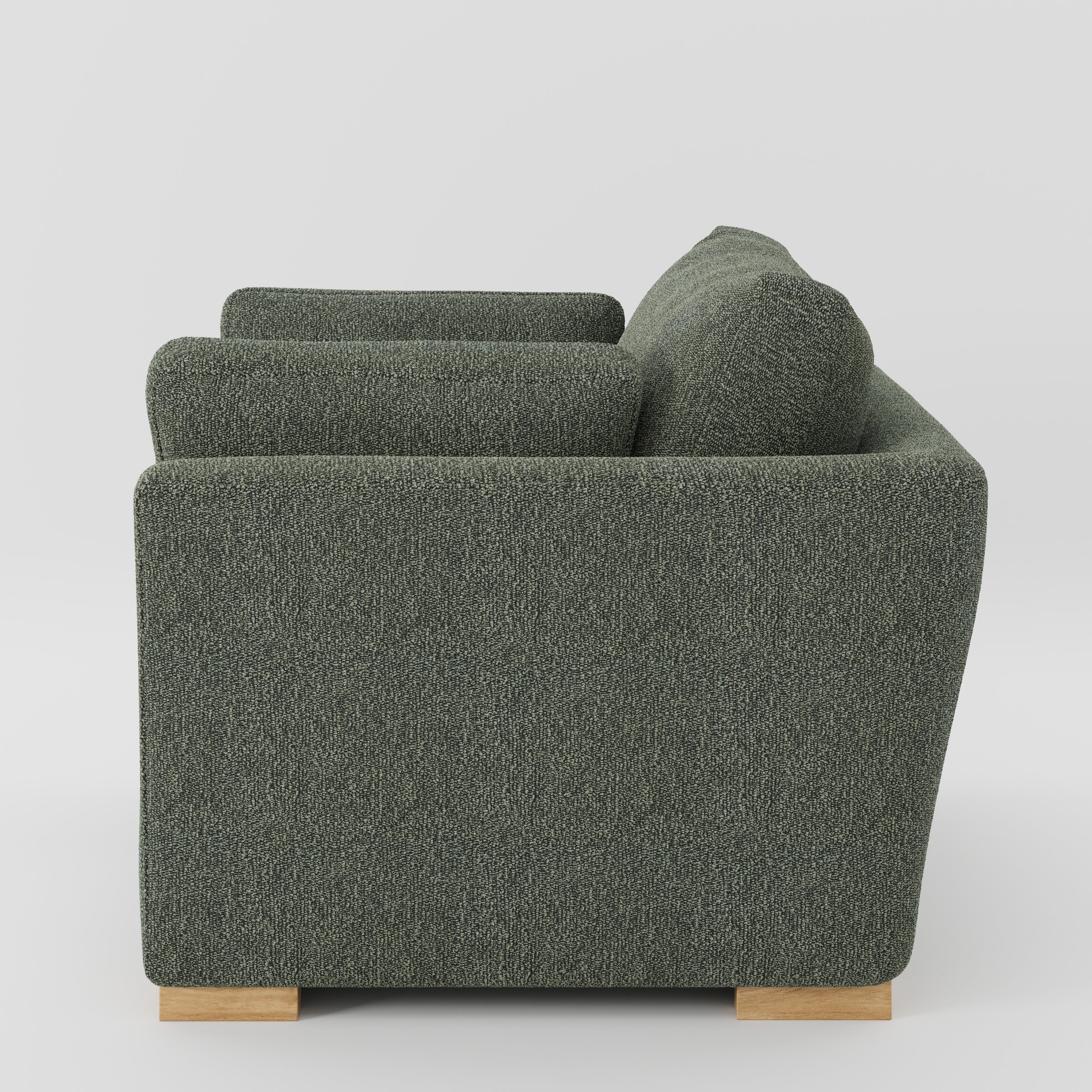 Stowe armchair in Kilda Boucle Moss shown in side profile displaying proportions and overall silhouette.
