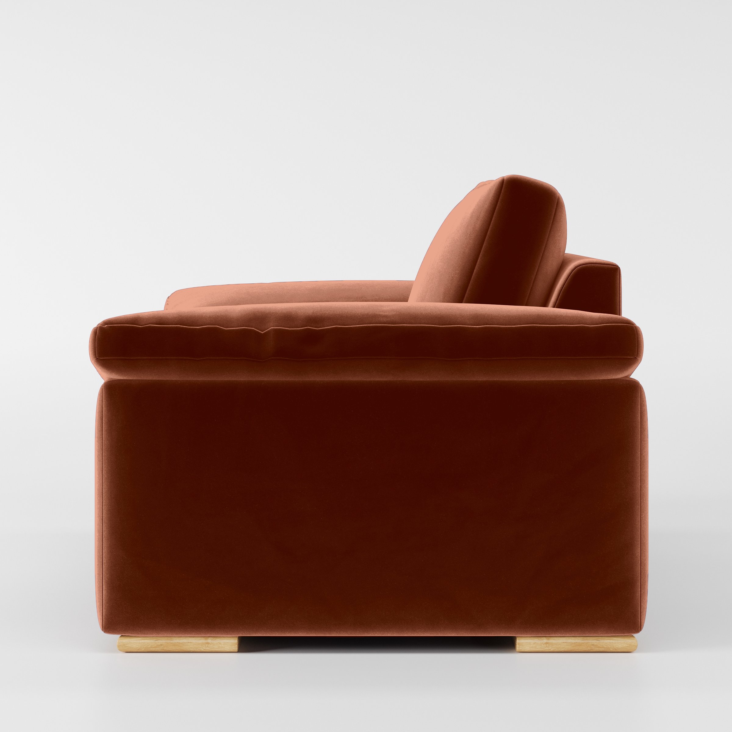 Side view of the Moy armchair upholstered in Plush EasyClean Velvet in Apricot.