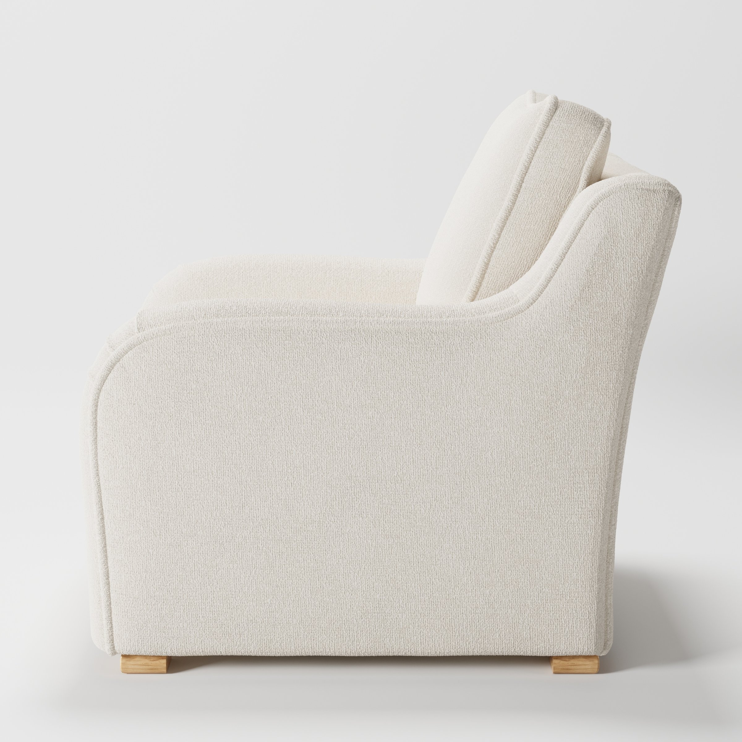 Cashel armchair in Kilda Boucle Cream shown in side profile displaying proportions and overall silhouette.