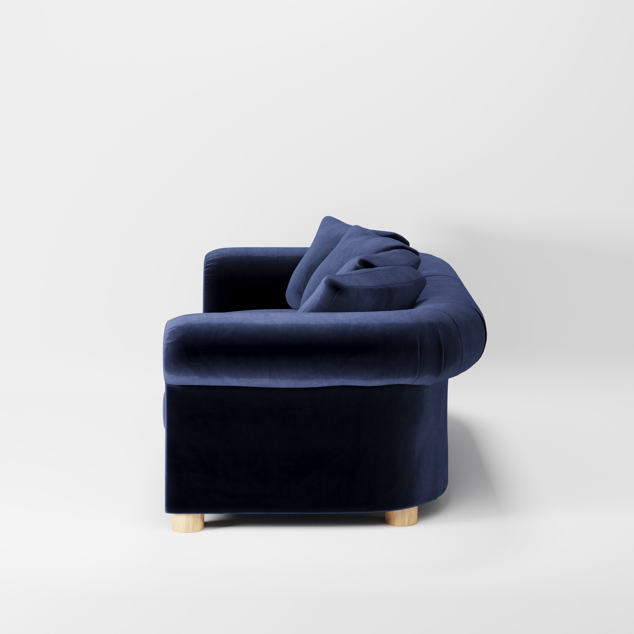 Windermere sofa in Noss Velvet Navy shown in side profile displaying proportions and overall silhouette.