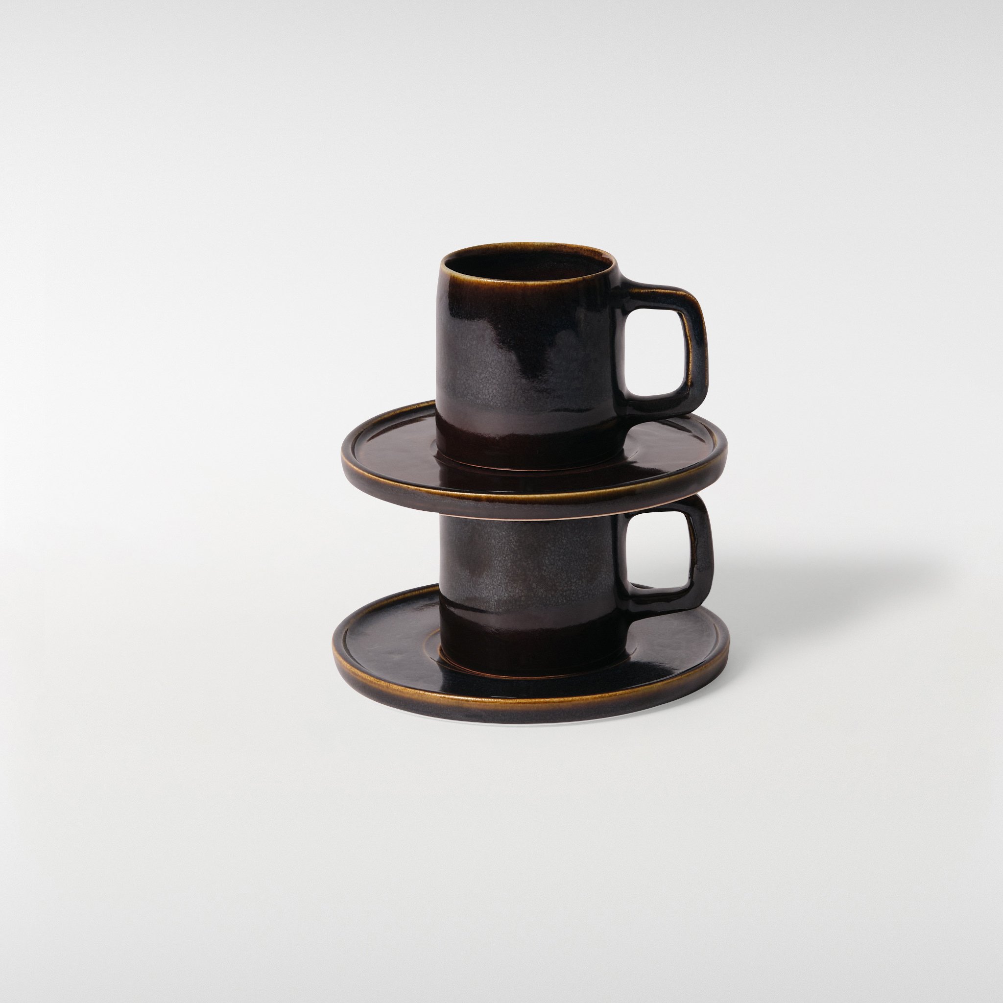 Two midnight glazed ceramic cup and saucer sets stacked, showcasing modular form, clean geometry and rich glaze finish