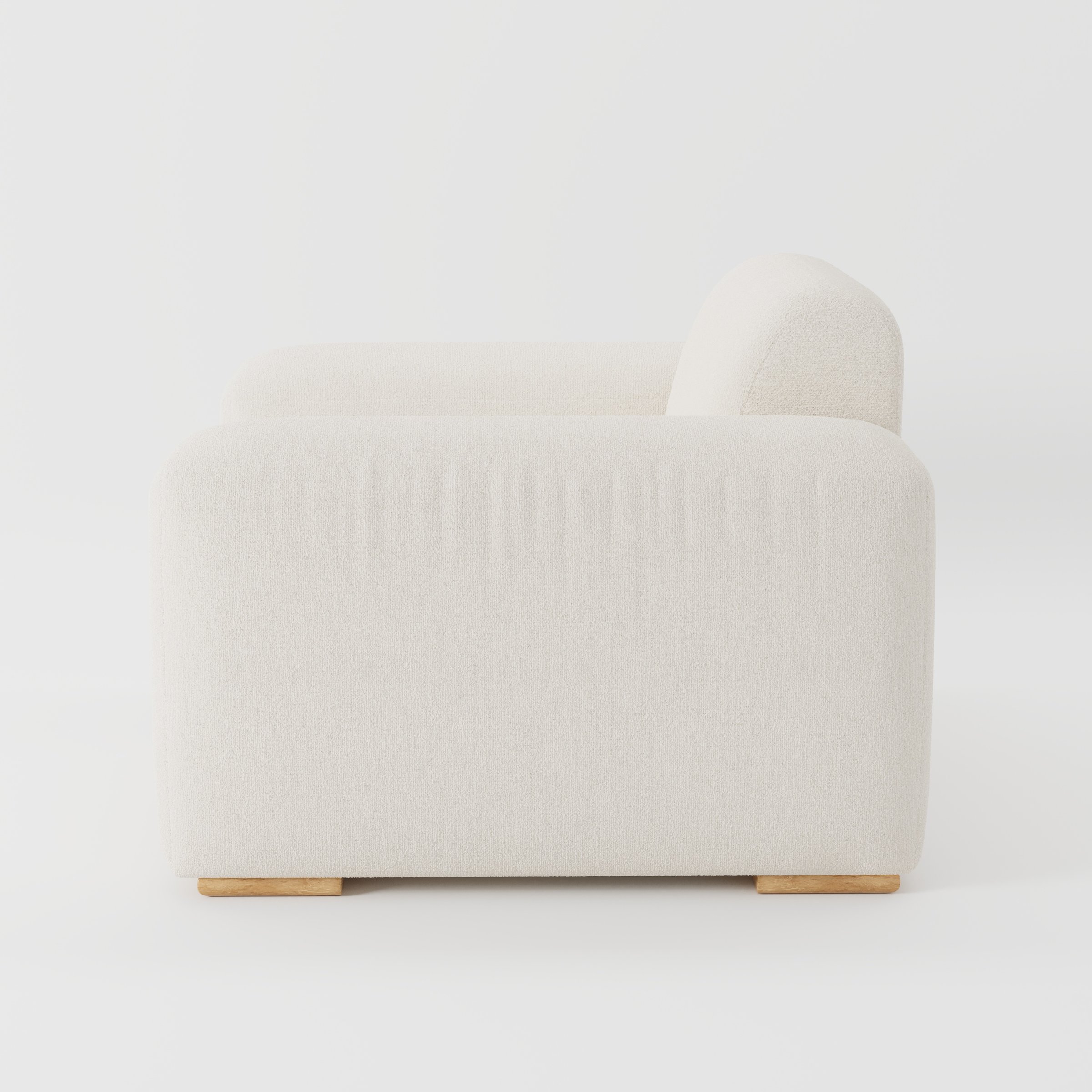Darwell armchair in Kilda Boucle Cream shown in side profile displaying proportions and overall silhouette.