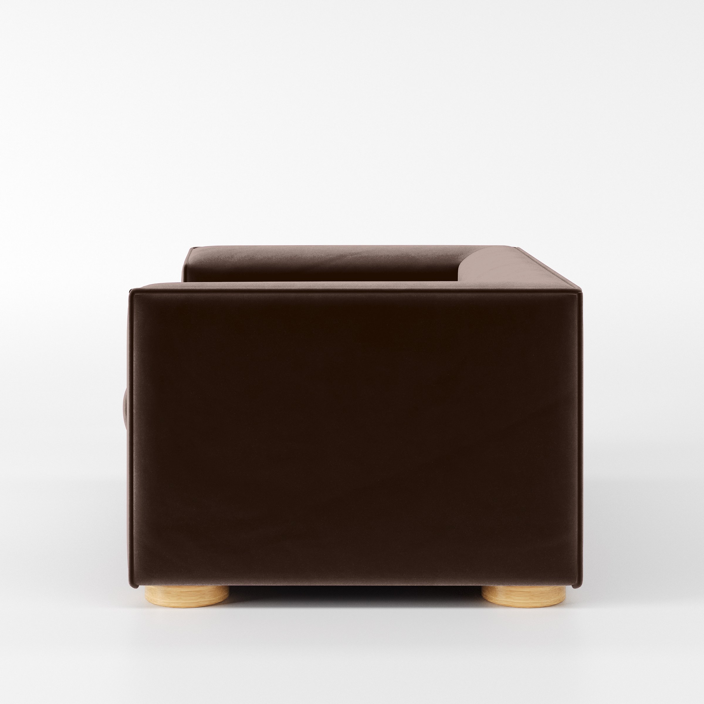 Side view of the Feale armchair upholstered in Plush EasyClean Velvet in Mole.