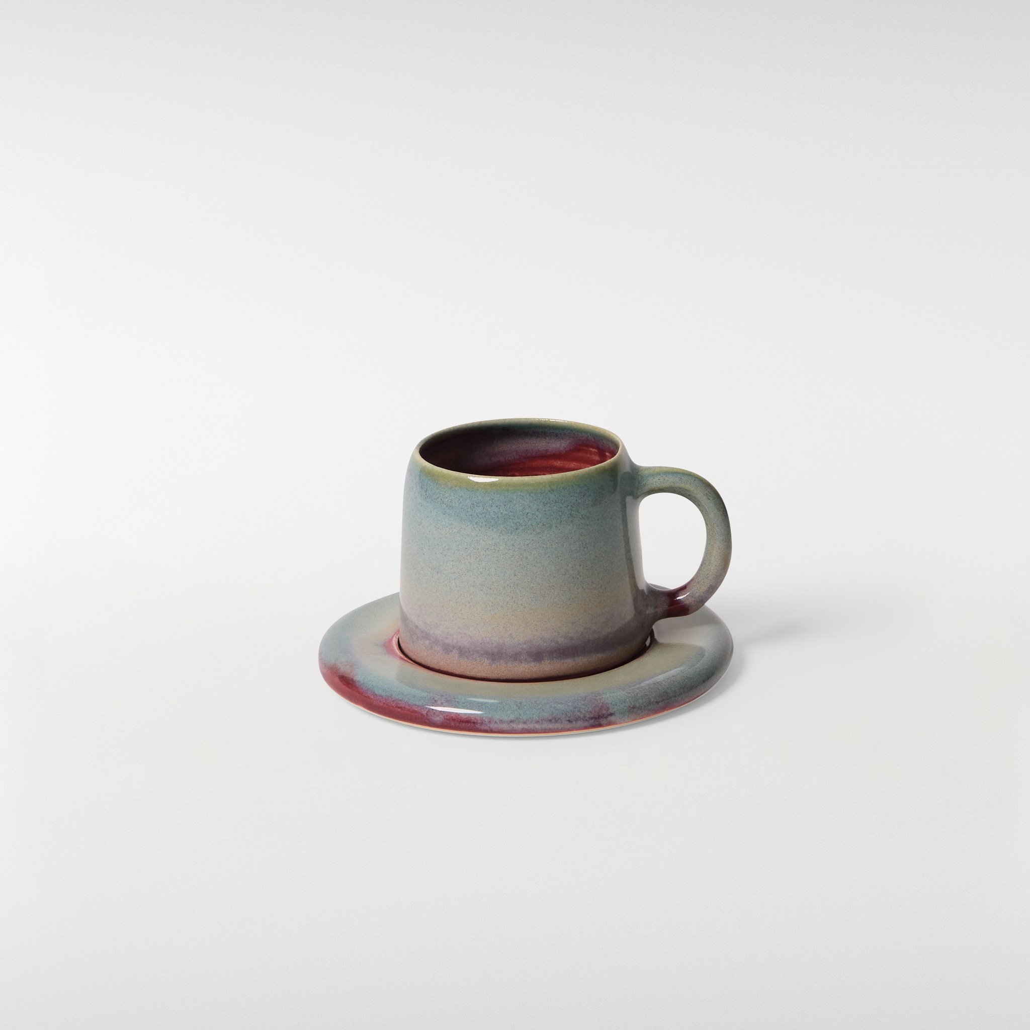 Loam glazed ceramic cup and saucer set, front angle showing rounded silhouette, single handle and layered glaze tones