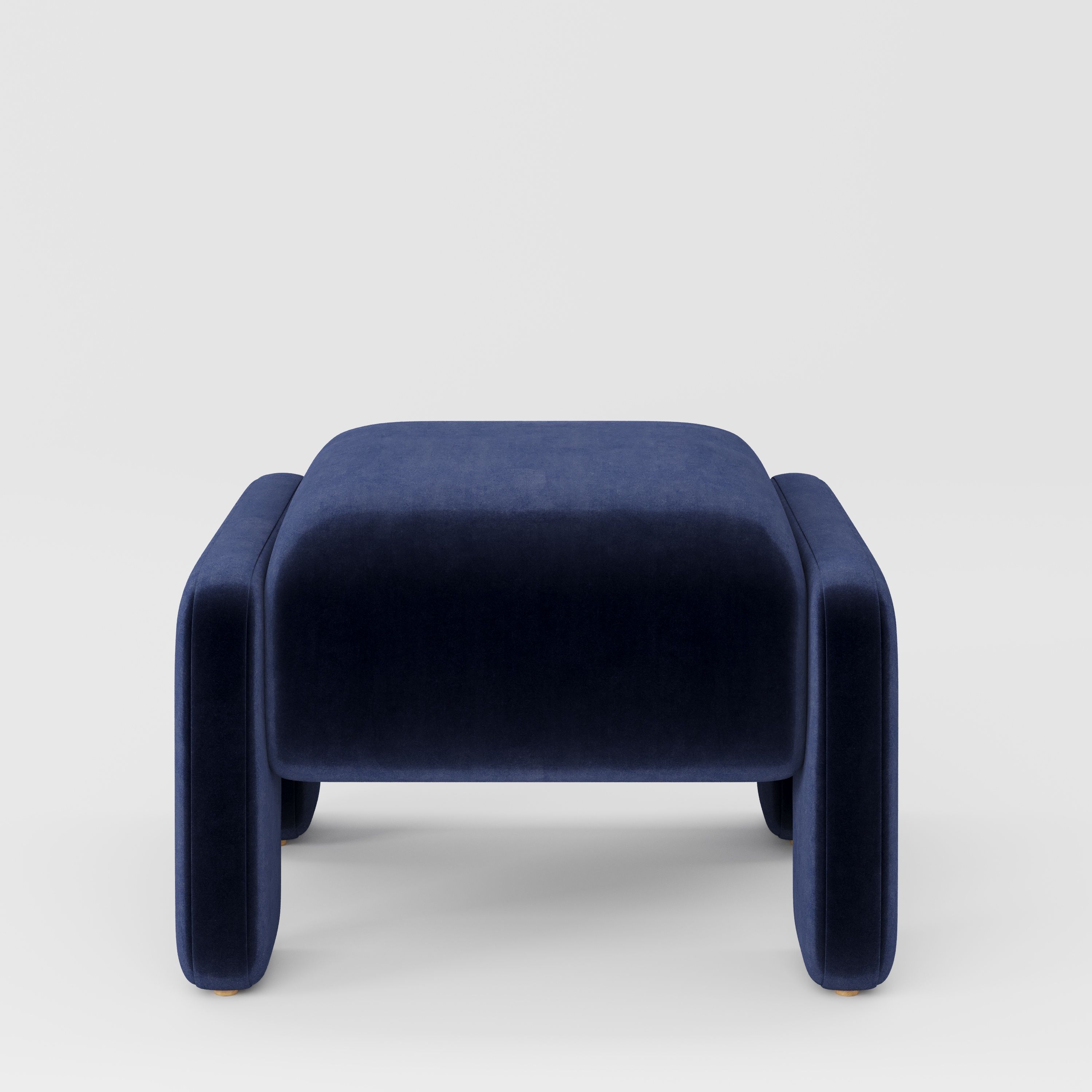 Inny footstool in Noss velvet navy fabric, front view showing sculpted shape and deep tonal finish