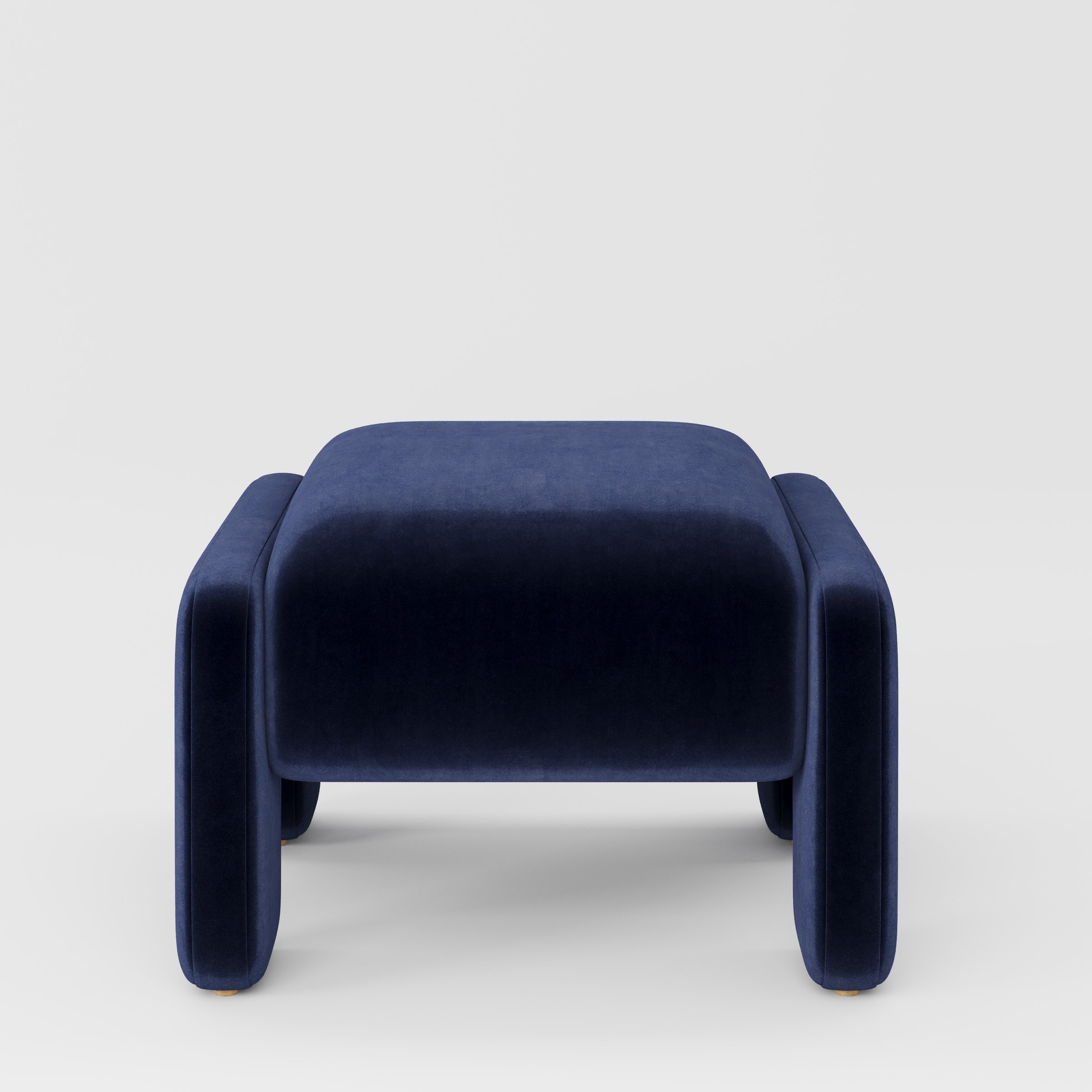 Inny footstool in Noss velvet navy fabric, front view showing sculpted shape and deep tonal finish