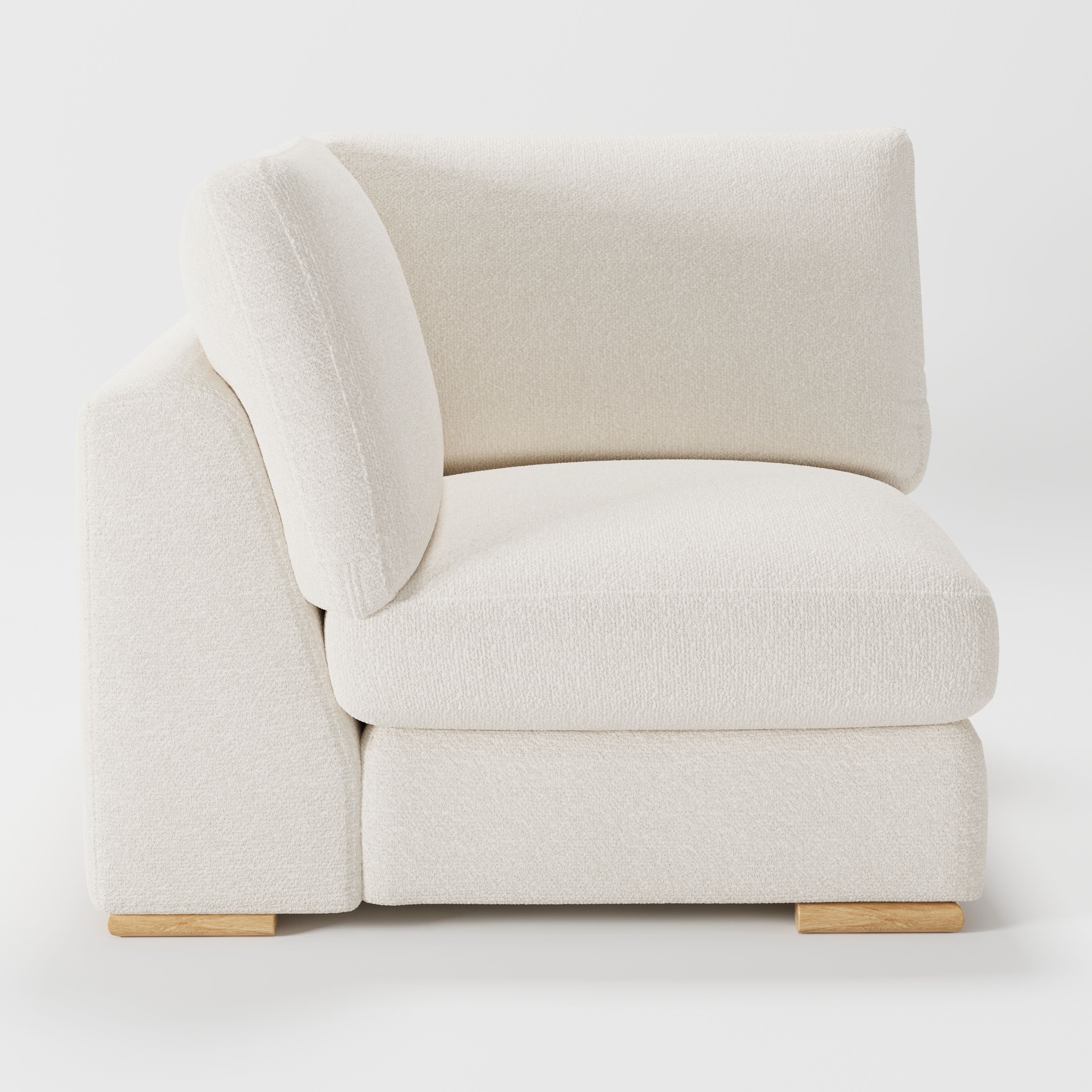 Olton corner unit in Kilda bouclé cream fabric, left side view showing sculpted arm and light texture