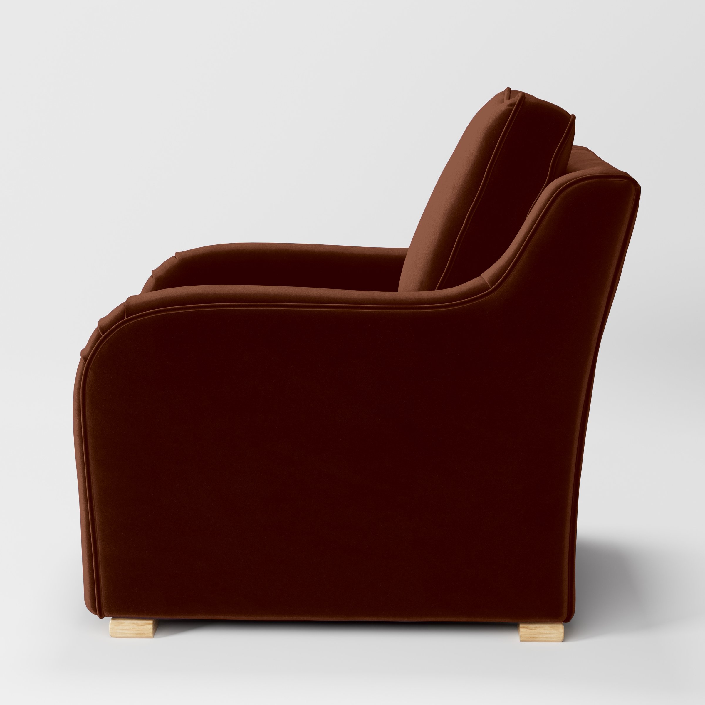 Side view of the Cashel armchair upholstered in Plush EasyClean Velvet in Maple.