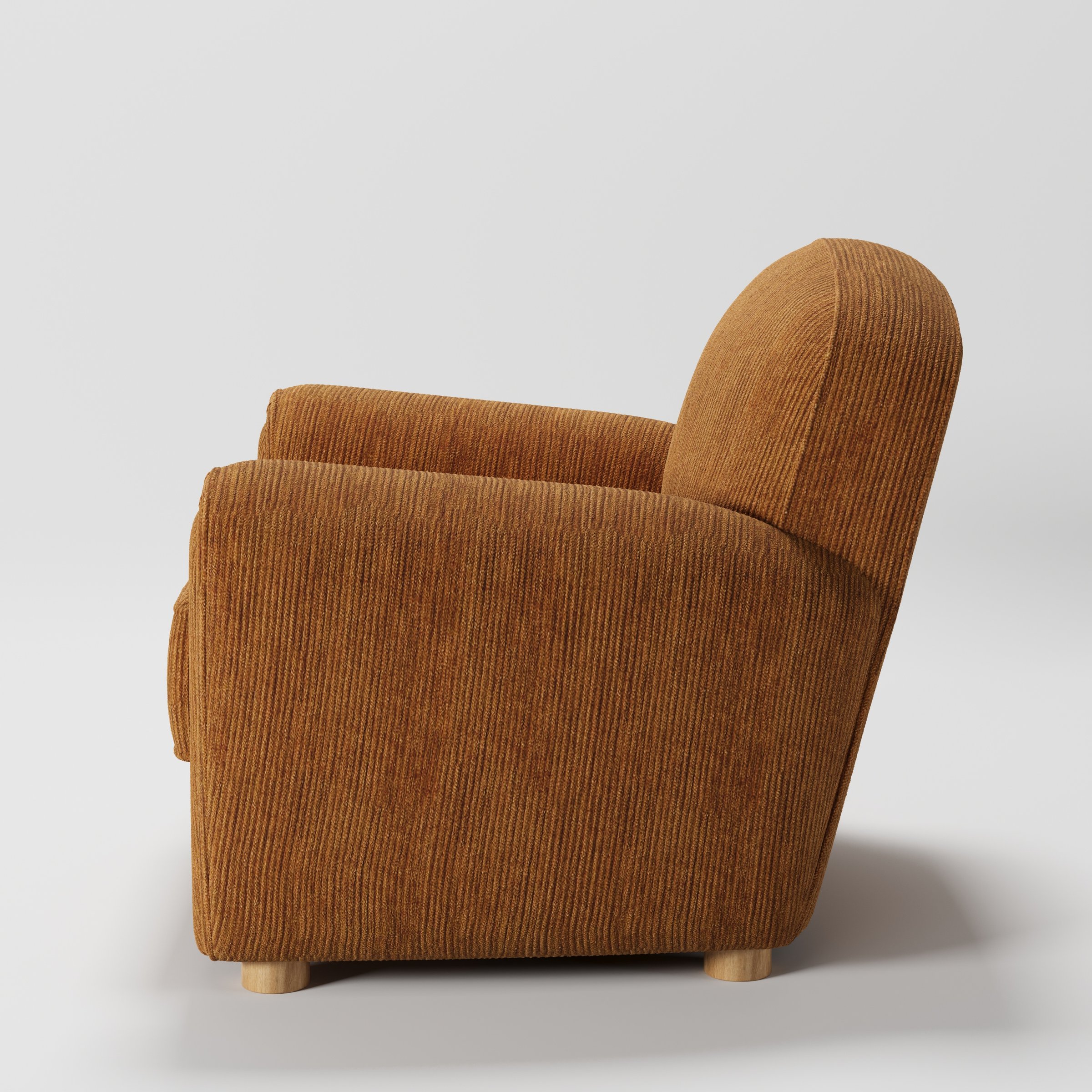Fergus armchair in Caldey Velvet Corduroy Tobacco shown in side profile displaying proportions and overall silhouette.