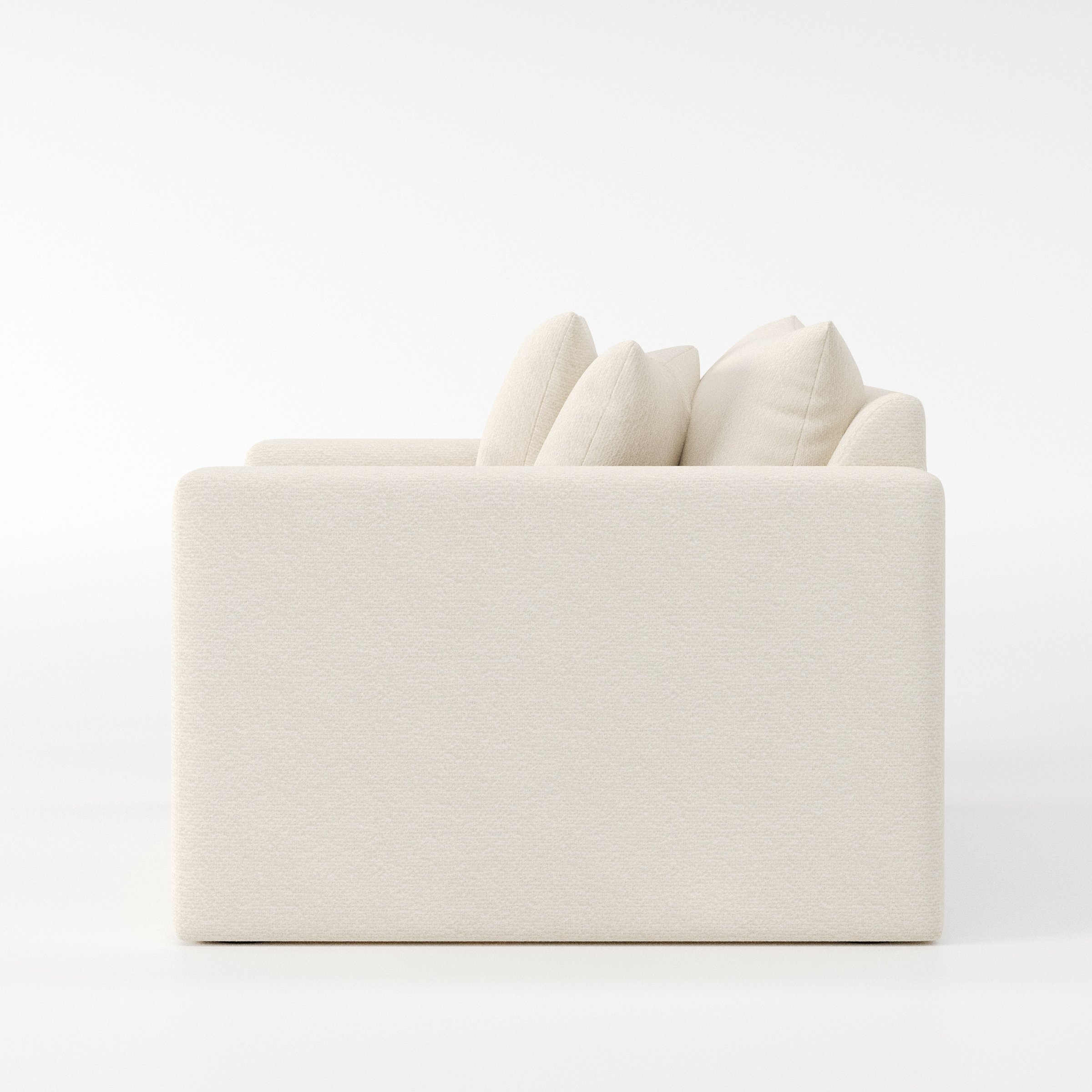 Coniston armchair in Kilda Boucle Cream shown in side profile displaying proportions and overall silhouette.