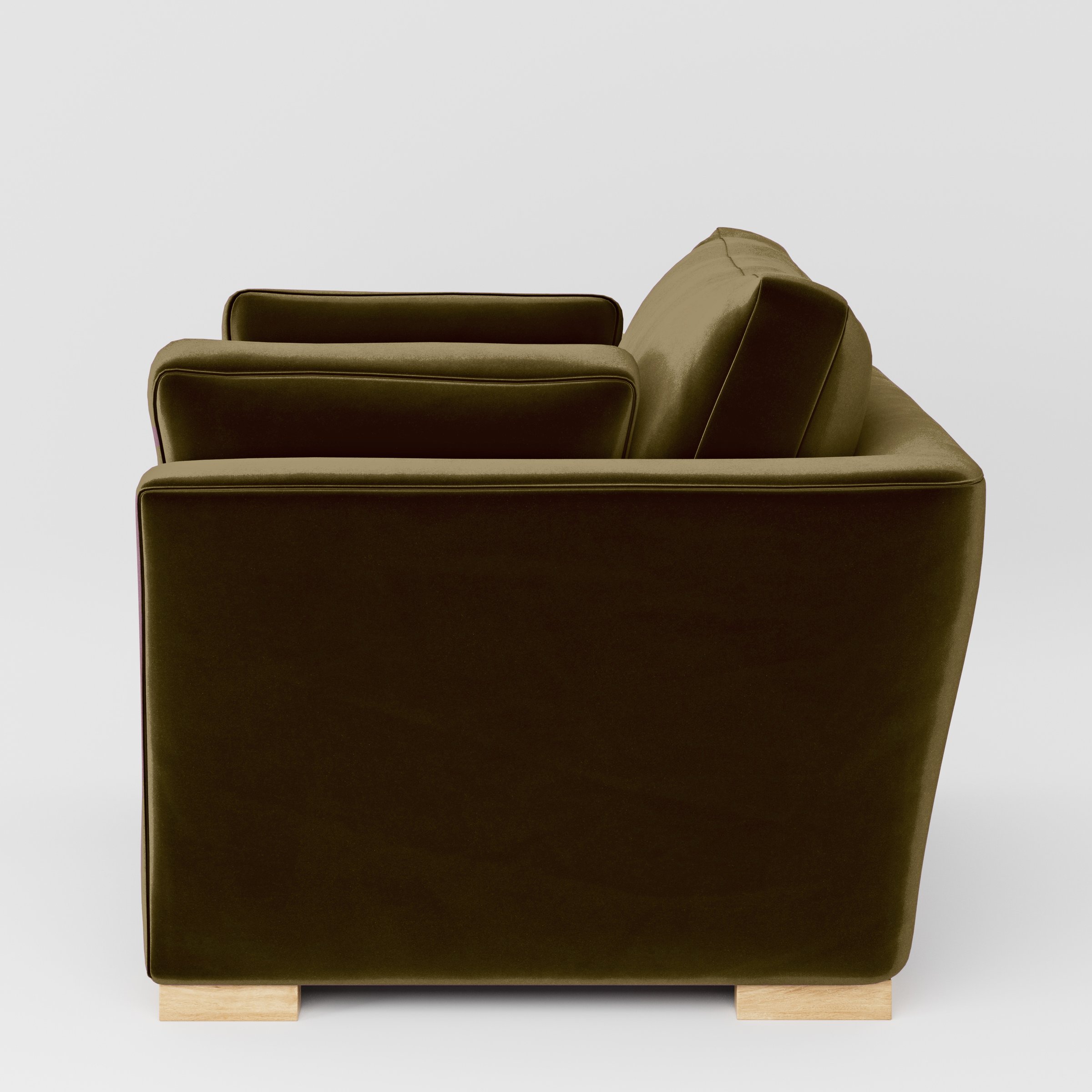 Side view of the Stowe armchair upholstered in Plush EasyClean Velvet in Cedar.