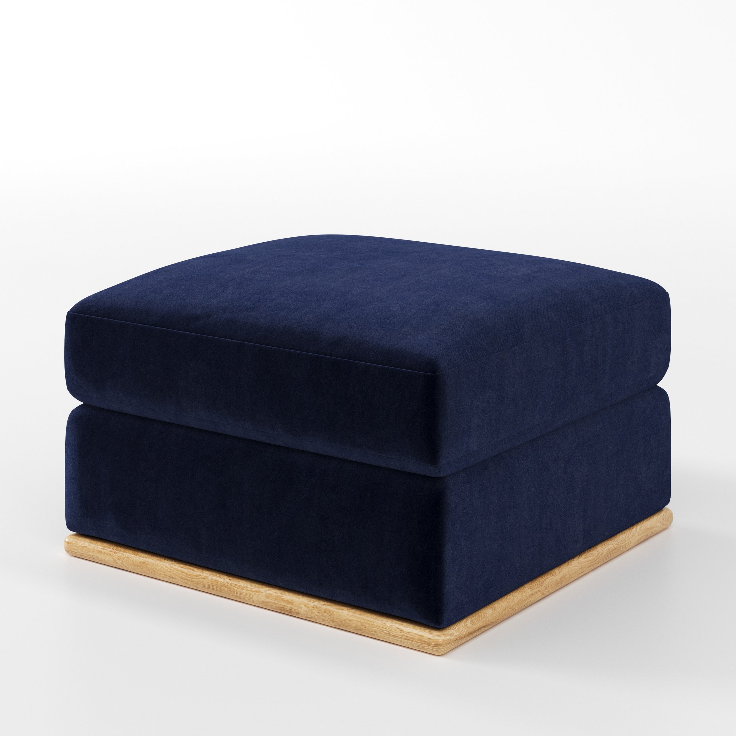 Cusher footstool in Noss Velvet Navy shown at a diagonal angle highlighting structured form and wooden plinth base.