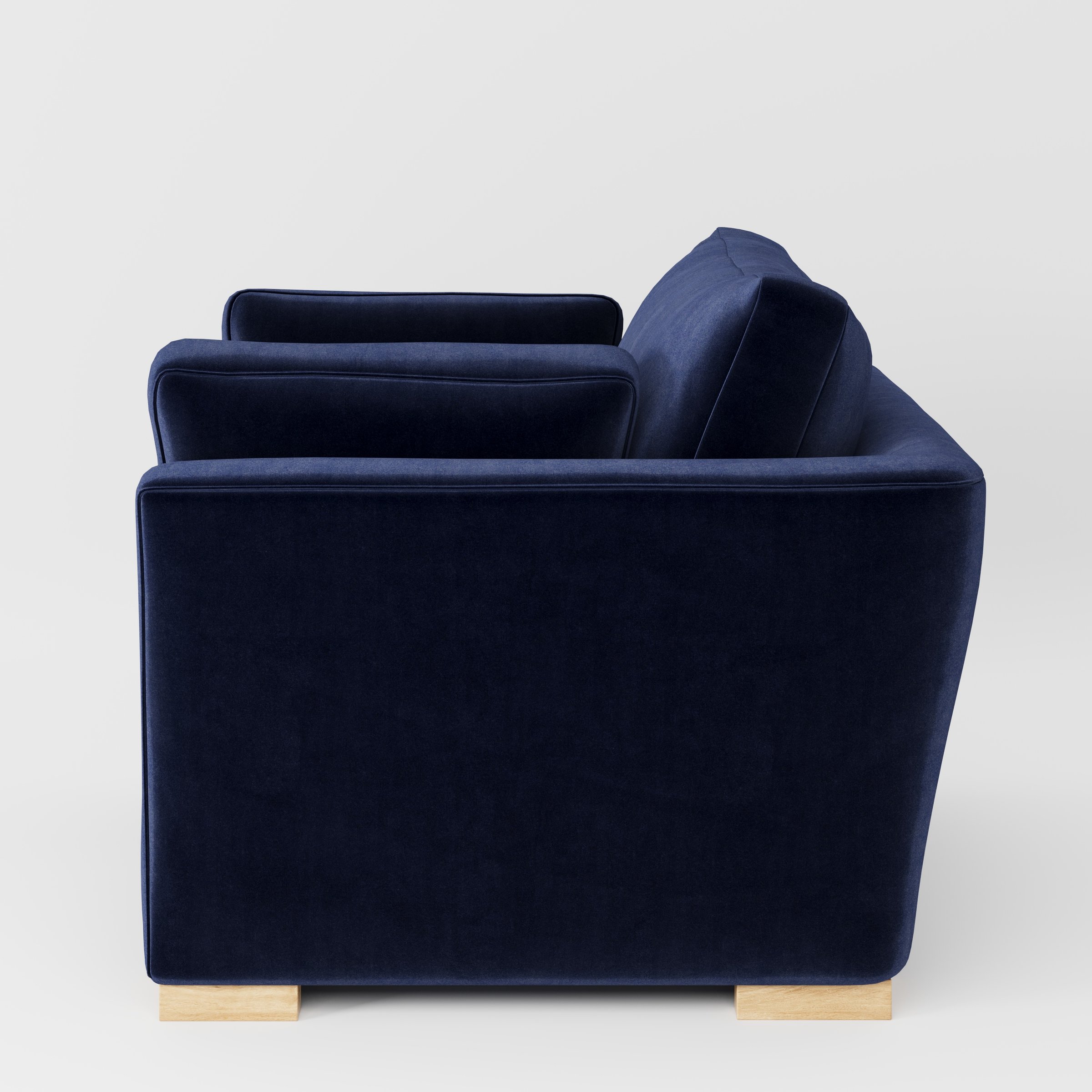 Stowe armchair in Noss Velvet Navy shown in side profile displaying proportions and overall silhouette.