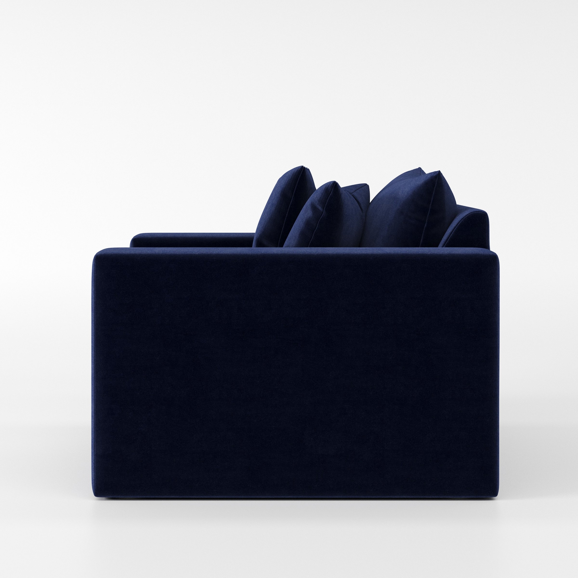 Coniston armchair in Noss Velvet Navy shown in side profile displaying proportions and overall silhouette.
