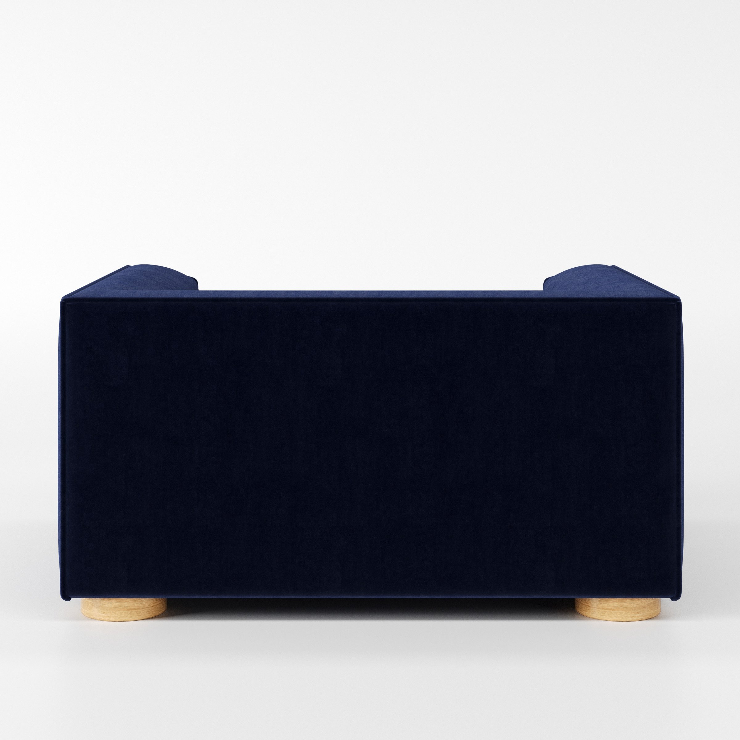 Feale armchair in Noss Velvet Navy shown from the rear highlighting backrest shape and upholstery finish.