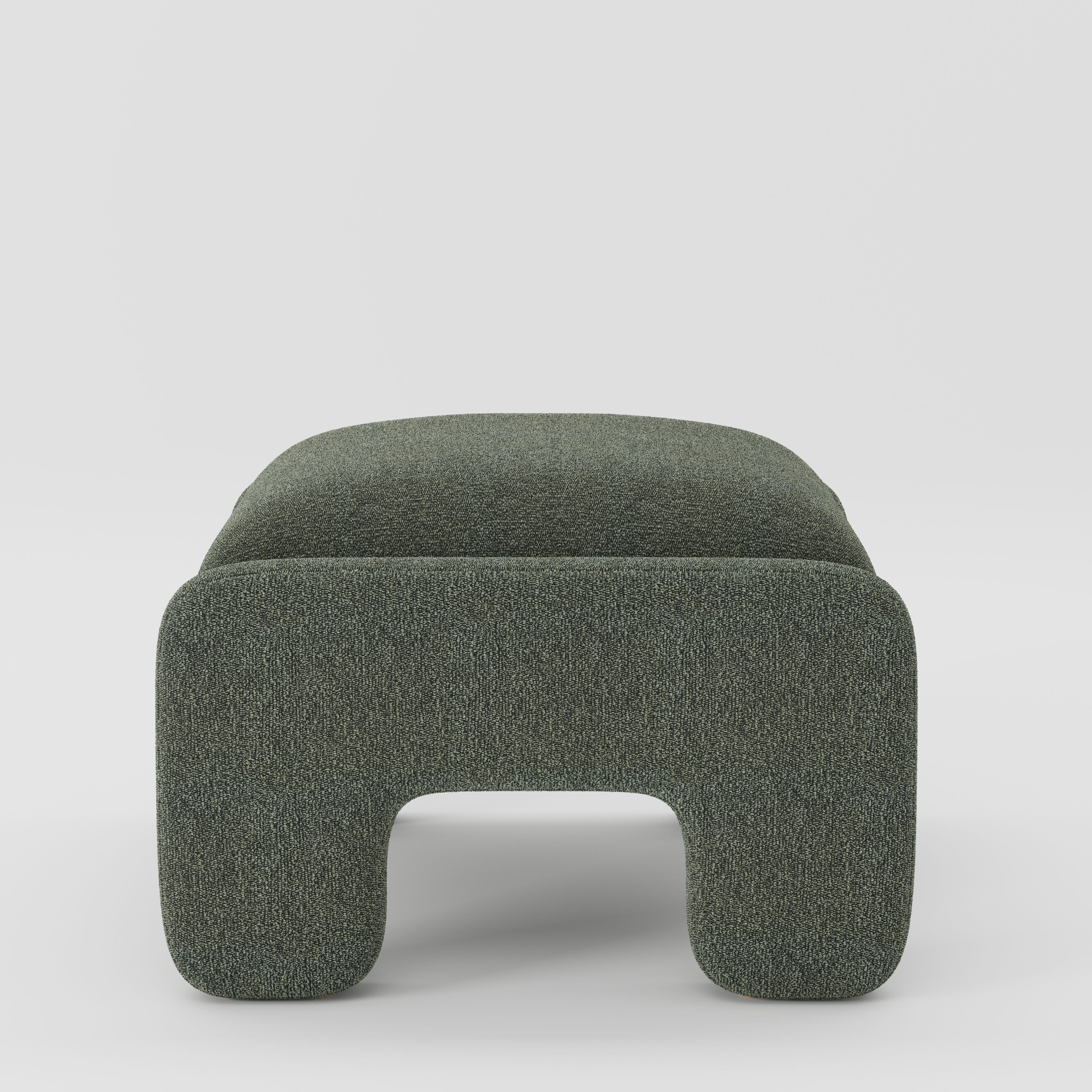 Inny footstool in Kilda bouclé moss fabric, side view emphasising low profile and soft sculptural edges