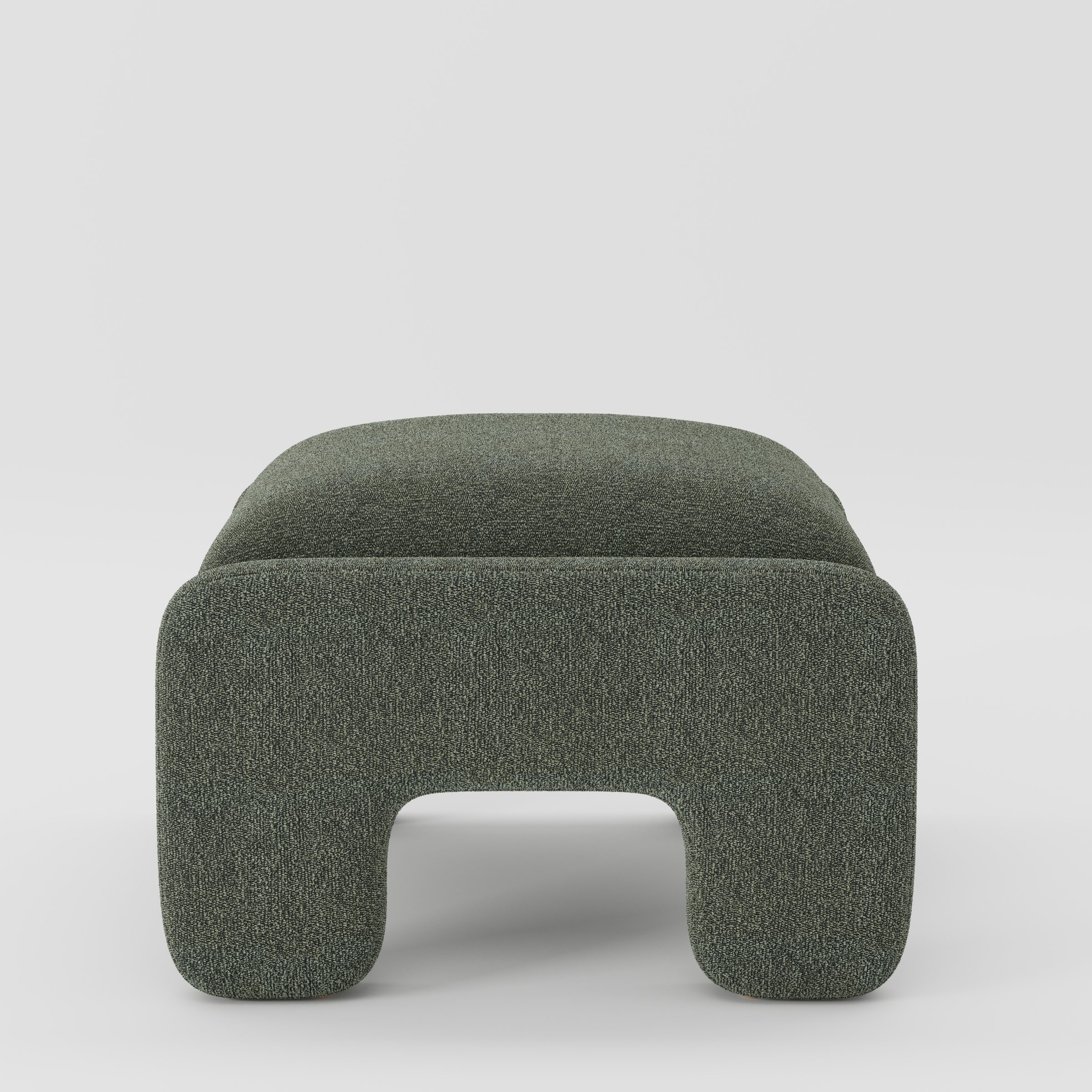 Inny footstool in Kilda bouclé moss fabric, side view emphasising low profile and soft sculptural edges