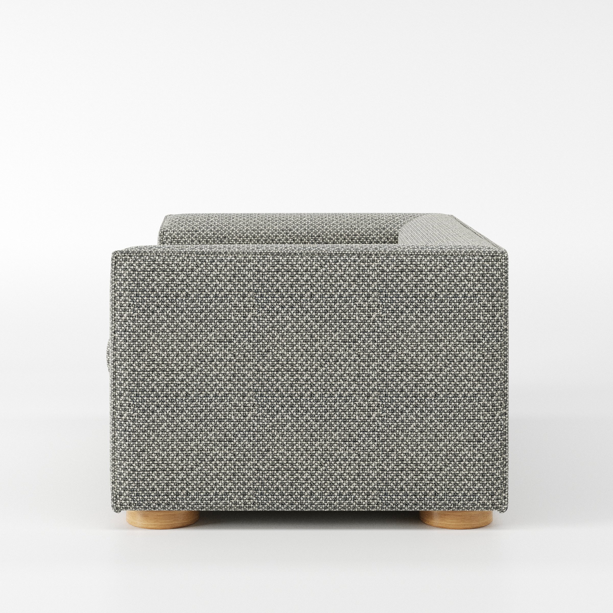 Feale armchair in Rousay Wool Blend Tar and Chalk shown in side profile displaying proportions and overall silhouette.