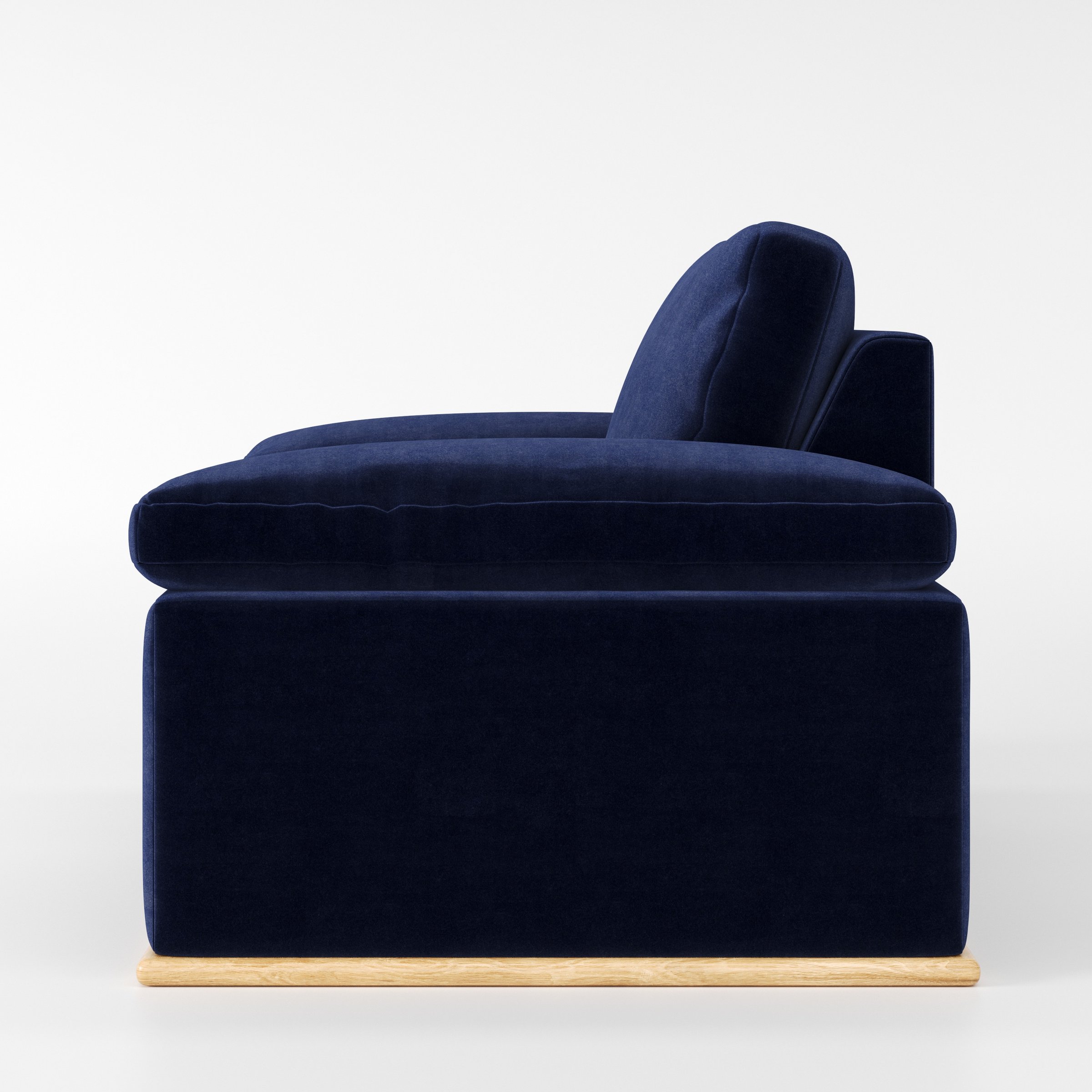 Cusher armchair in Noss Velvet Navy shown in side profile displaying proportions and overall silhouette.