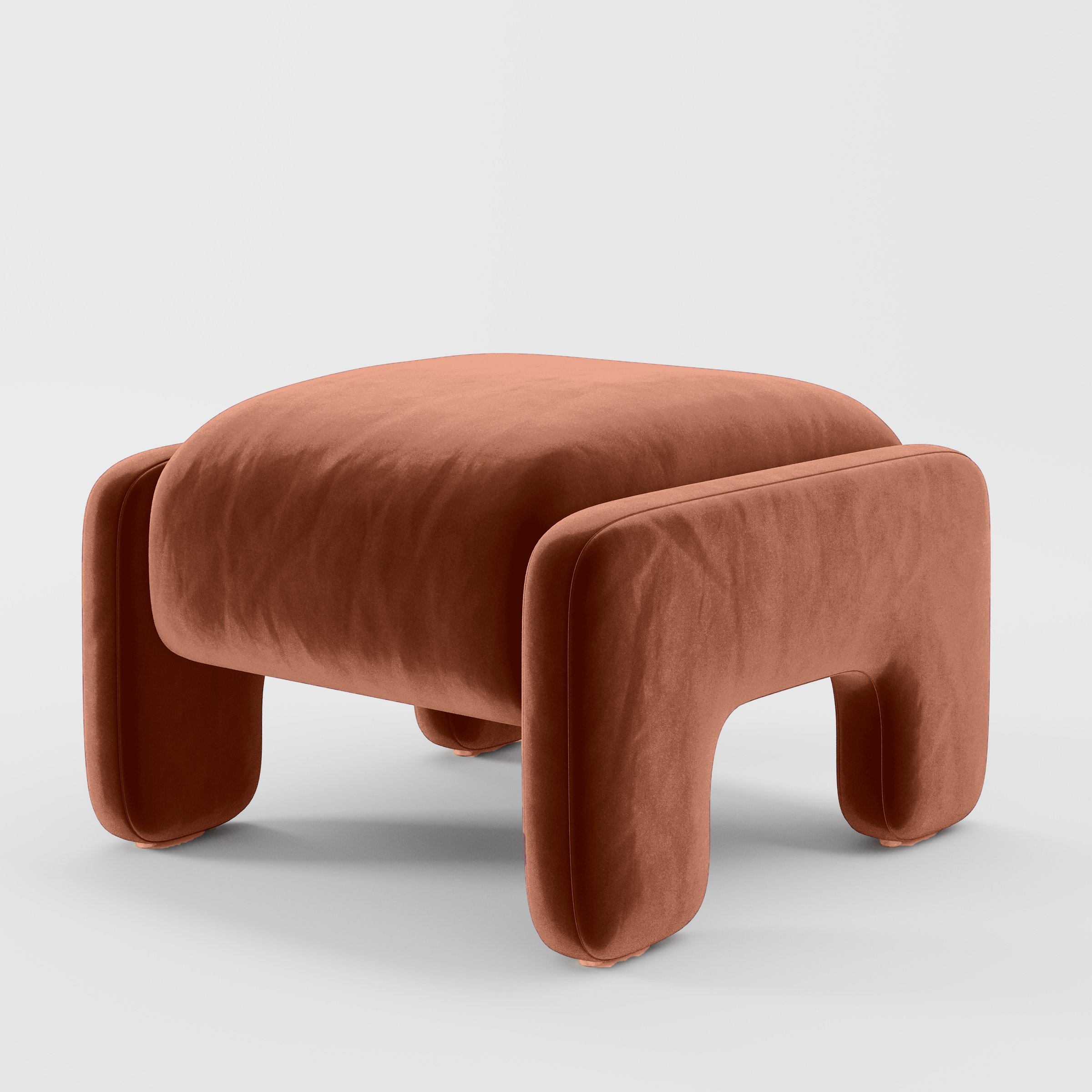 Diagonal view of the Inny footstool upholstered in Plush EasyClean Velvet in Apricot.
