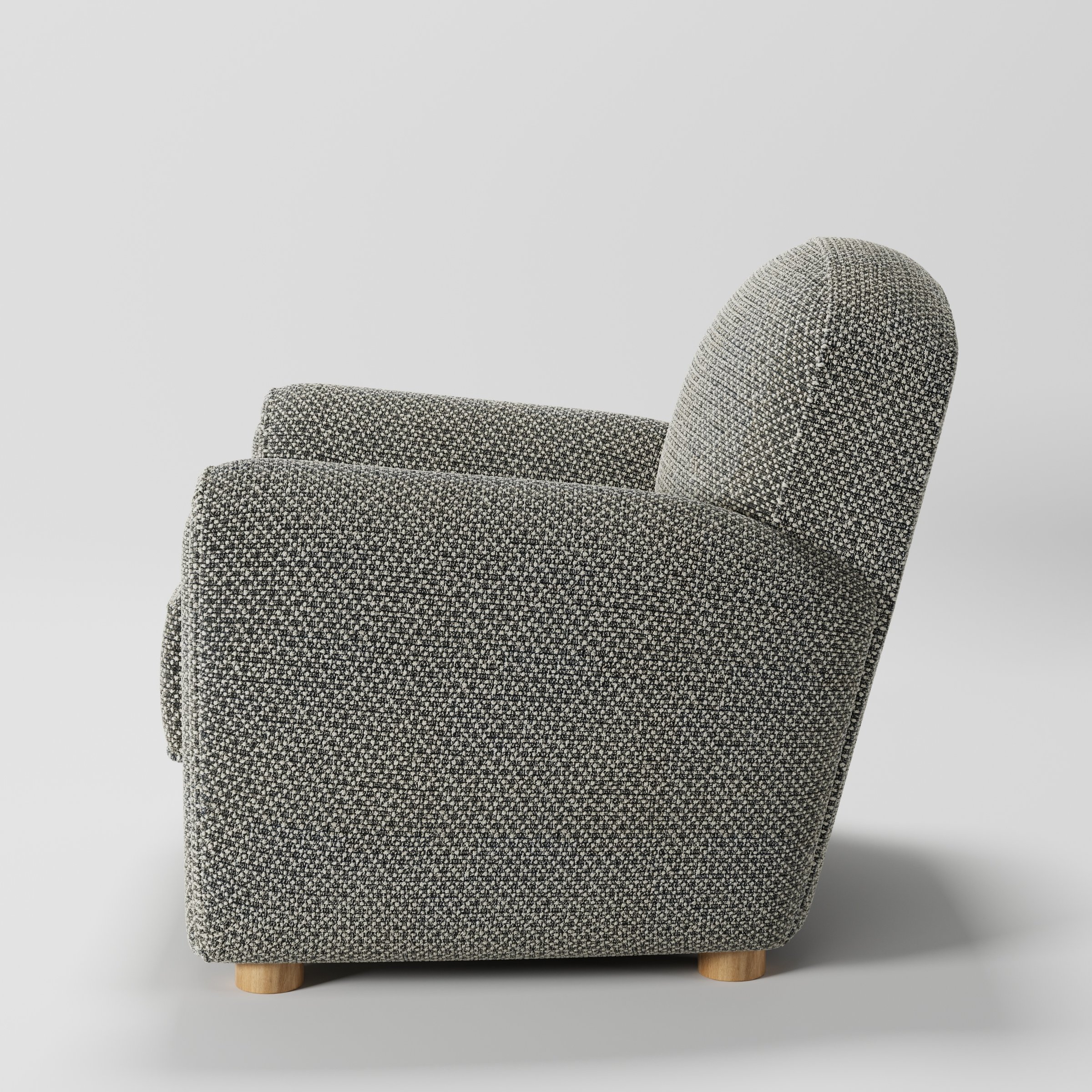 Fergus armchair in Rousay Wool Blend Tar and Chalk shown in side profile displaying proportions and overall silhouette.