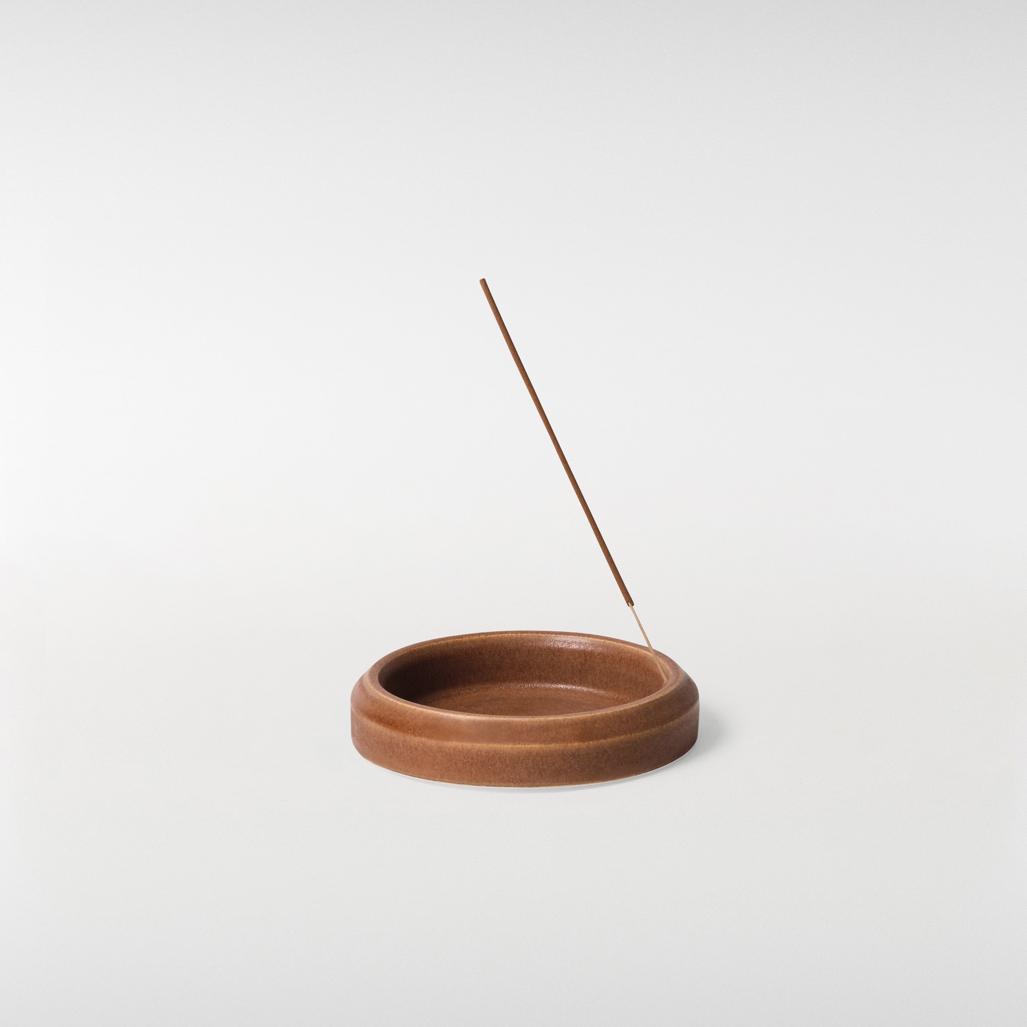 Chamfer Incense Holder in warm brown glaze with incense stick, shallow circular dish design