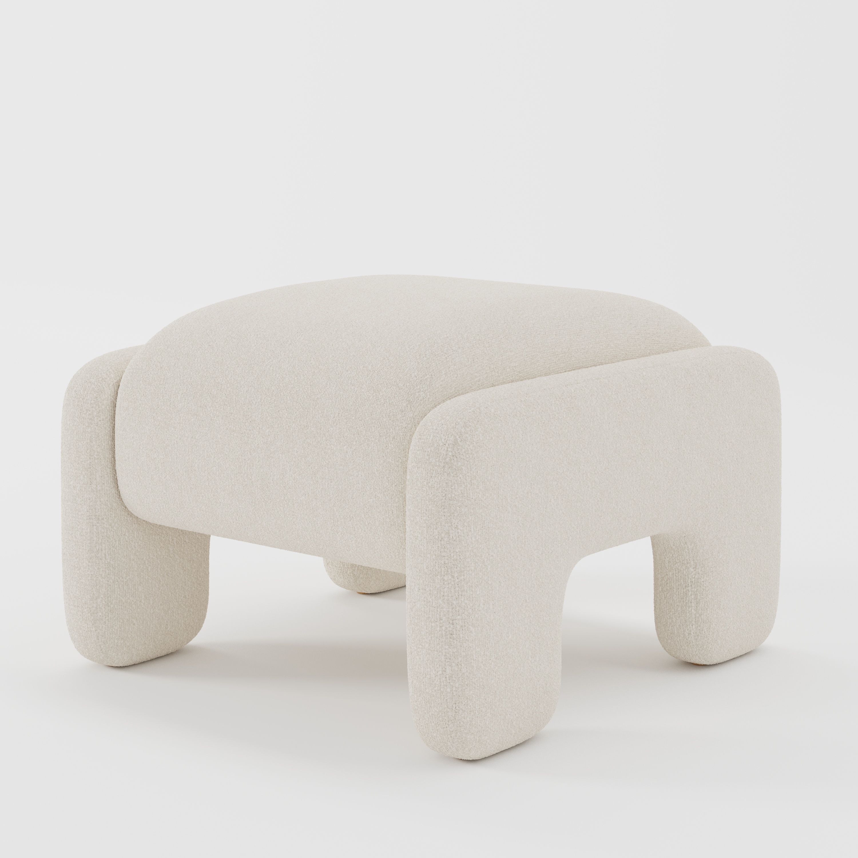 Inny footstool in Kilda bouclé cream fabric, diagonal view highlighting curved silhouette and subtle texture