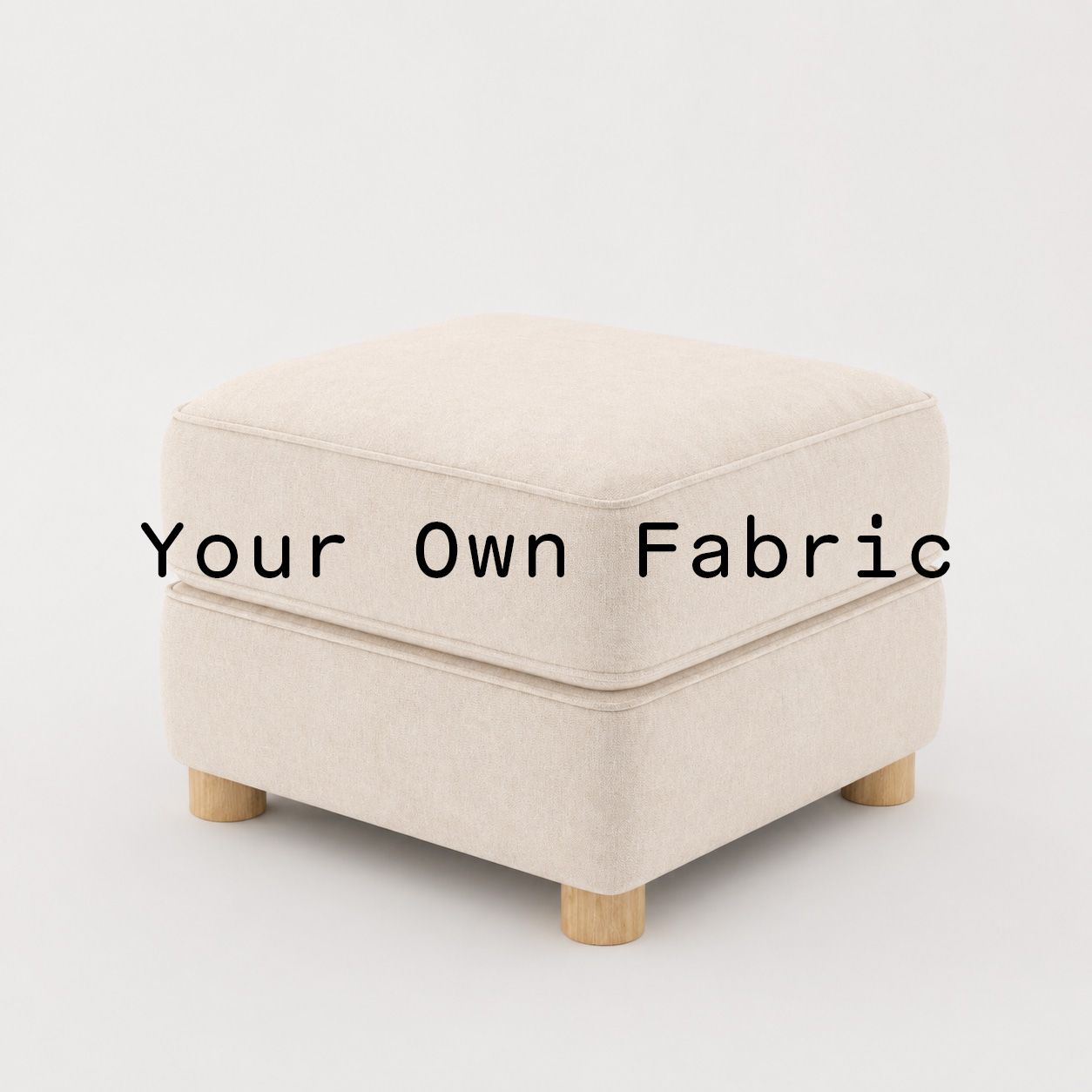 Diagonal view of the Fergus footstool upholstered in customers own material calico cotton fabric.