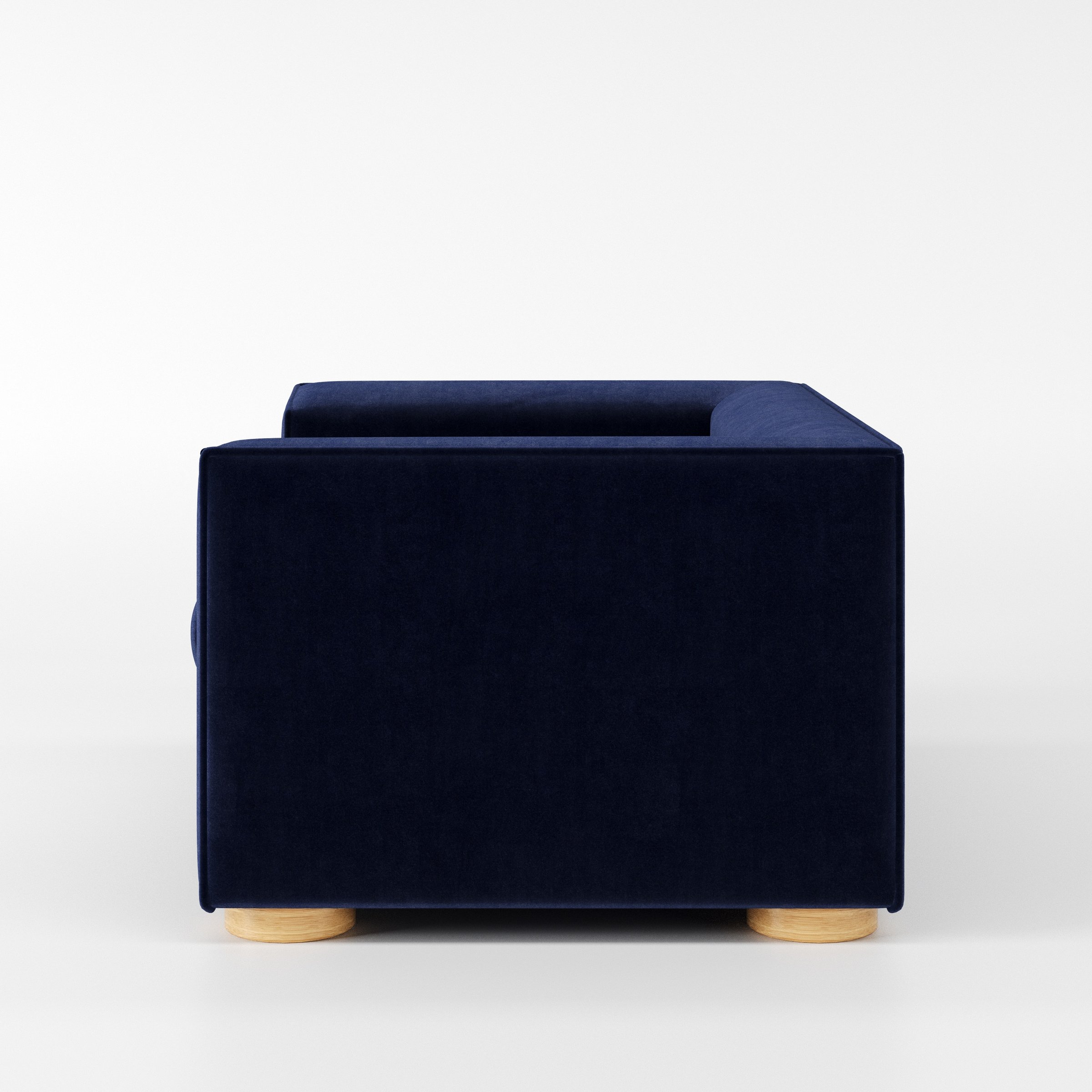 Feale armchair in Noss Velvet Navy shown in side profile displaying proportions and overall silhouette.