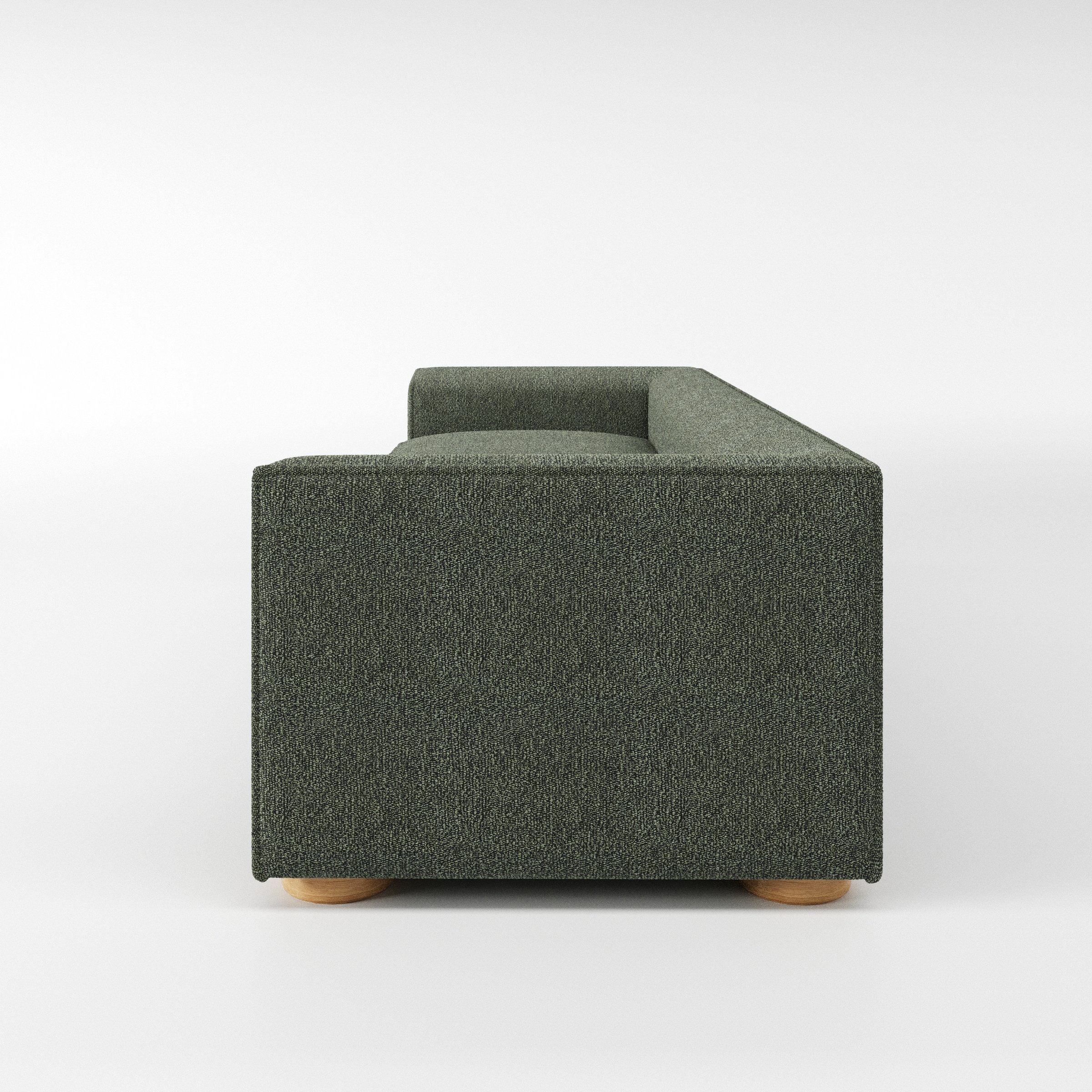 Feale sofa in Kilda Boucle Moss shown in side profile displaying proportions and overall silhouette.