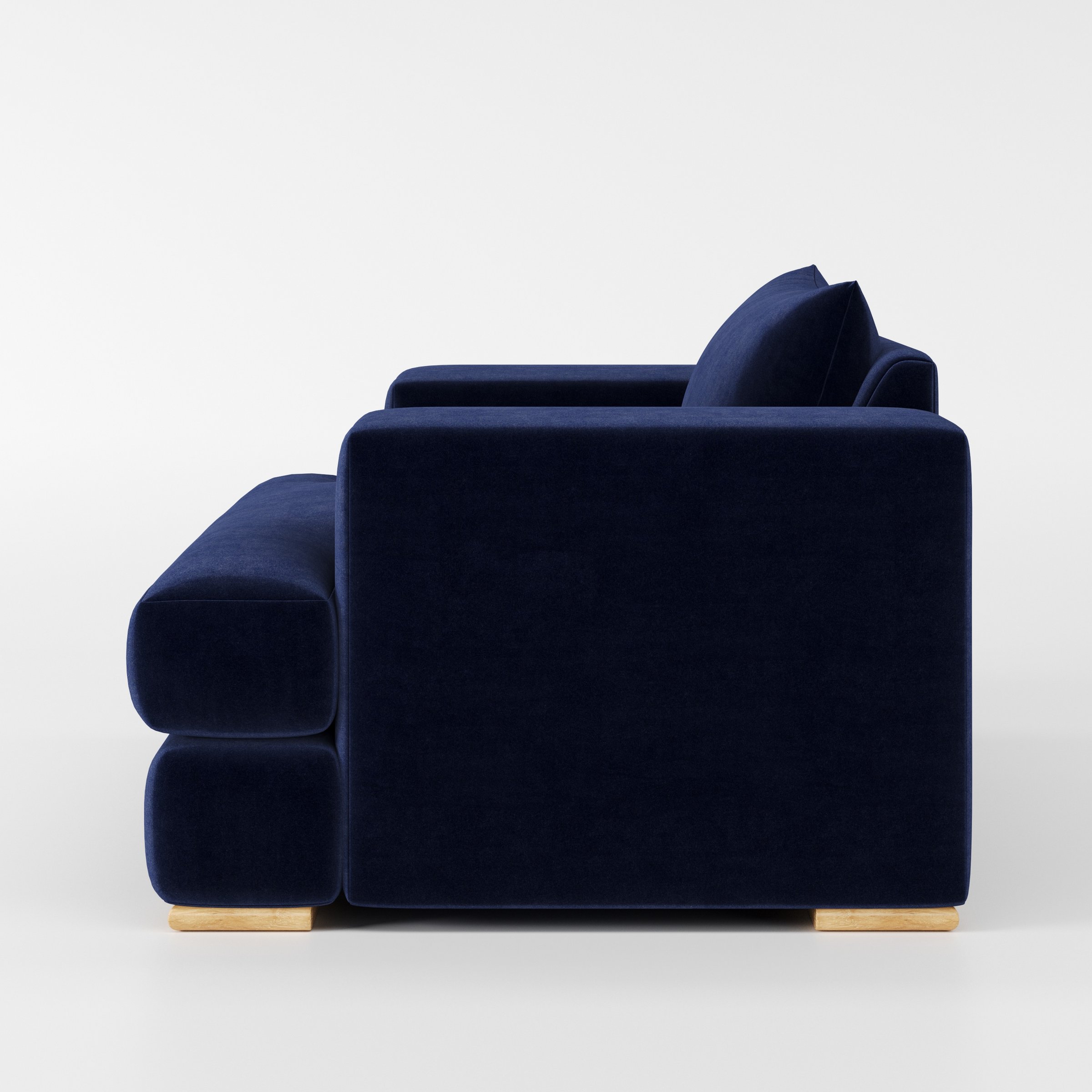 Fane armchair in Noss Velvet Navy shown in side profile displaying proportions and overall silhouette.