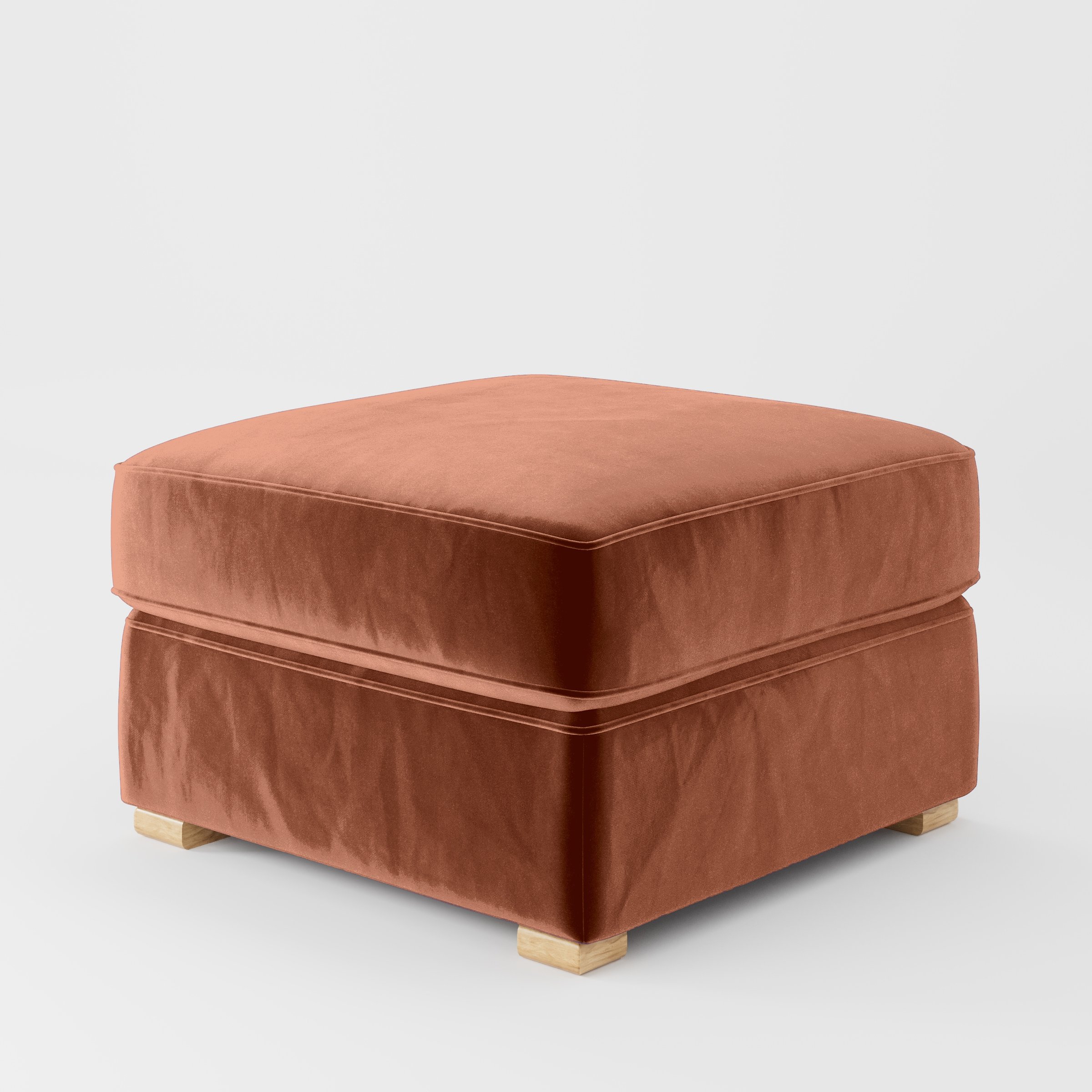 Diagonal view of the Cashel footstool upholstered in Plush EasyClean Velvet in Apricot.