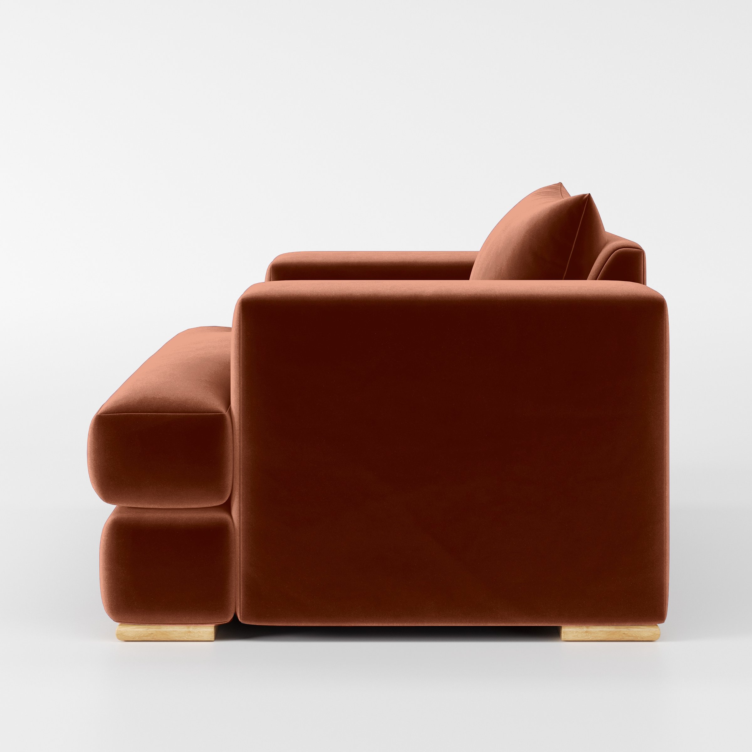 Side view of the Fane armchair upholstered in Plush EasyClean Velvet in Apricot.