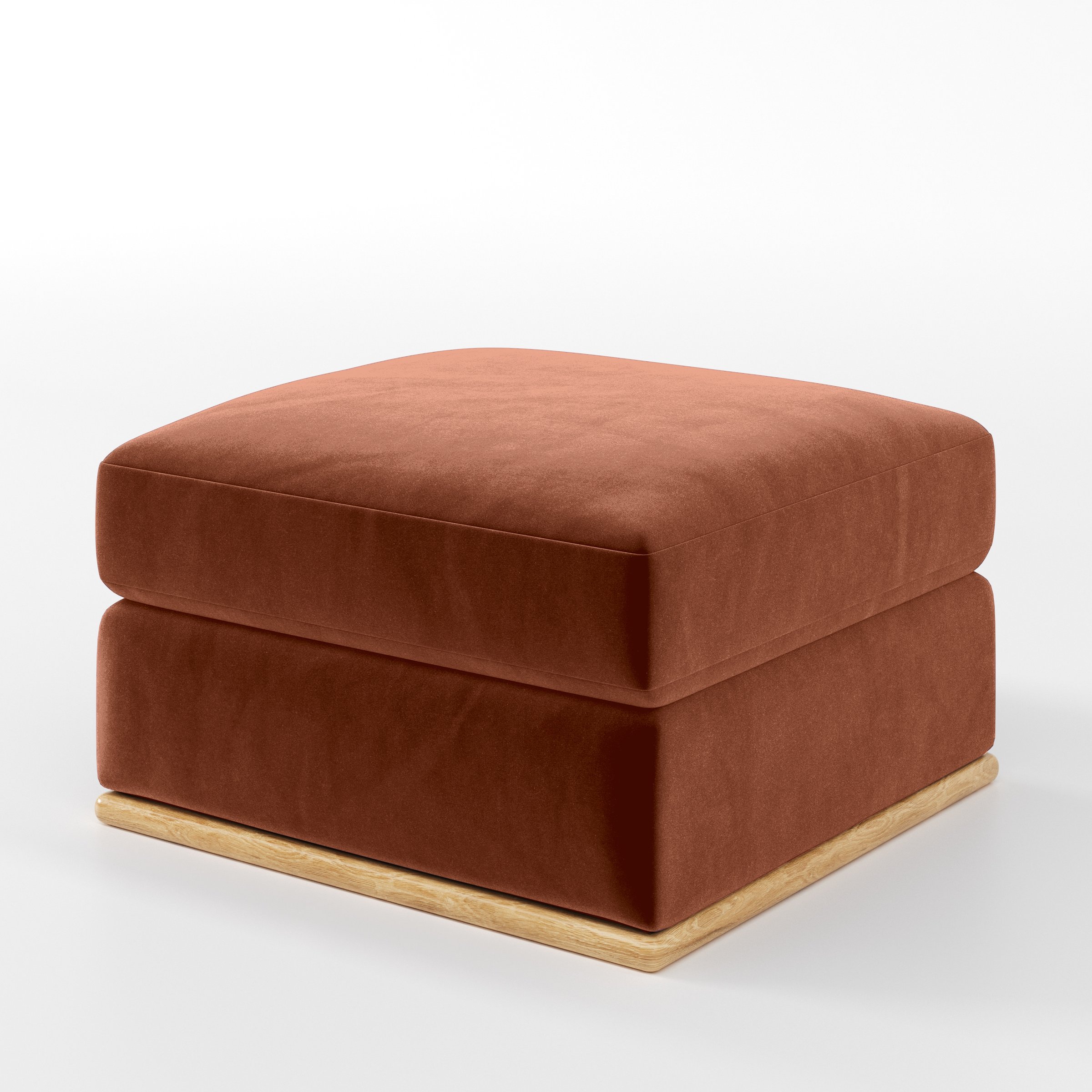Diagonal view of the Cusher footstool upholstered in Plush EasyClean Velvet in Apricot.