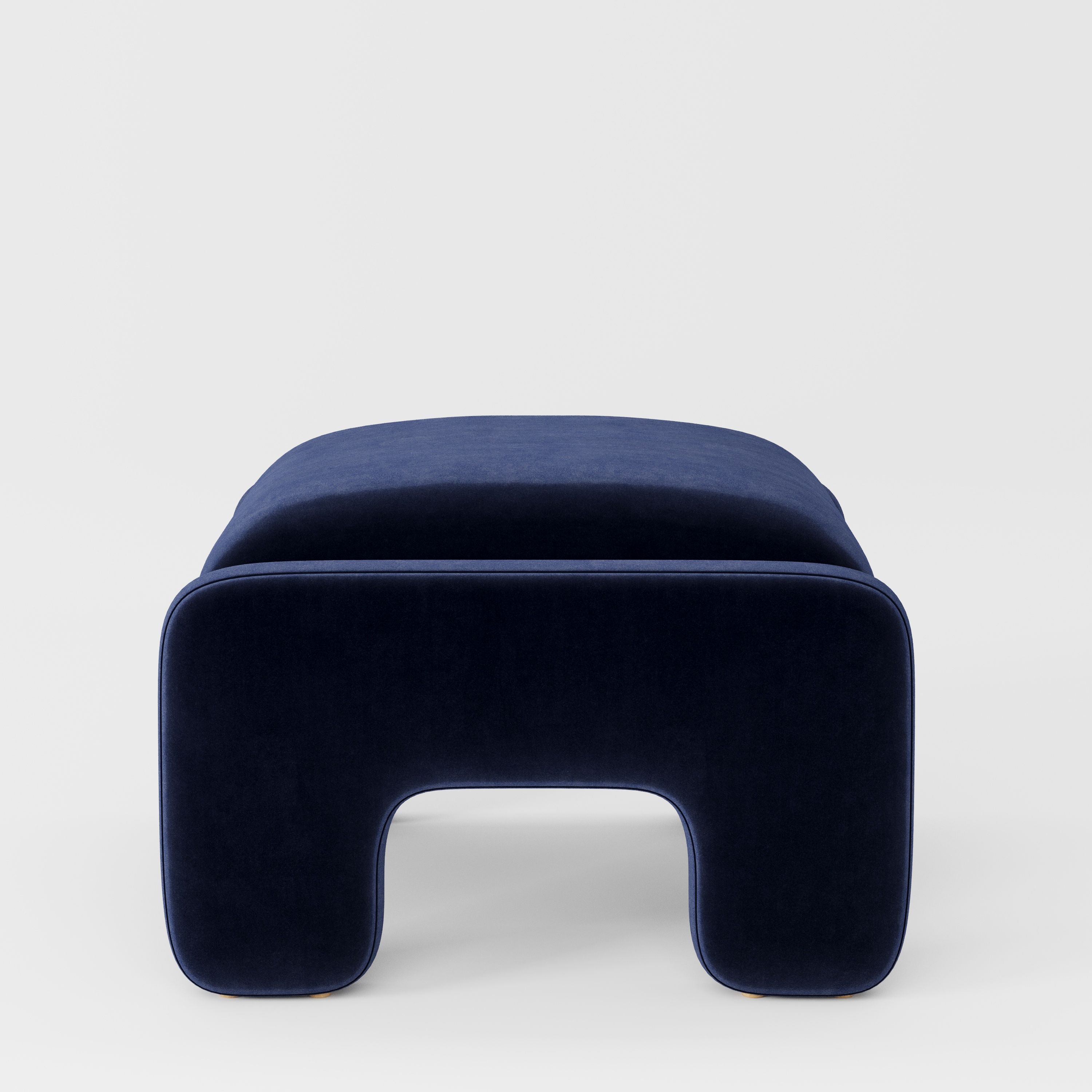 Inny footstool in Noss velvet navy fabric, side view emphasising clean lines and continuous upholstery