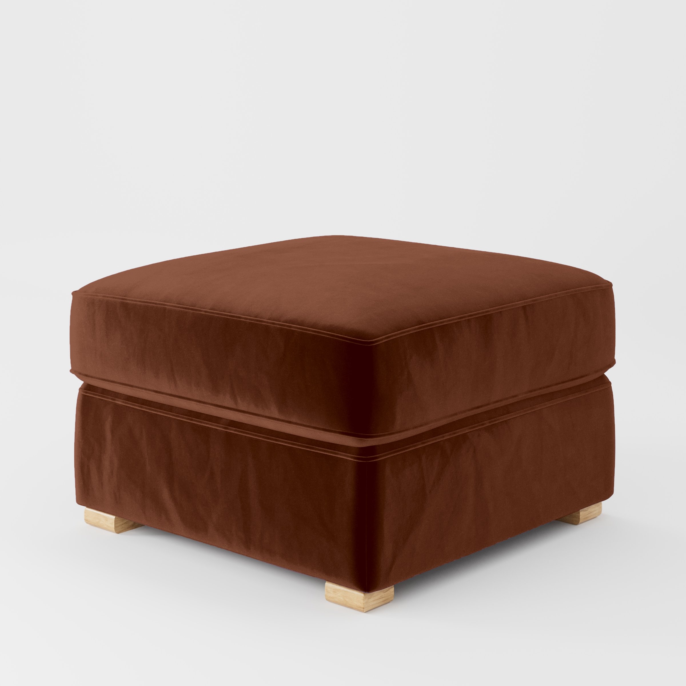 Diagonal view of the Cashel footstool upholstered in Plush EasyClean Velvet in Maple.