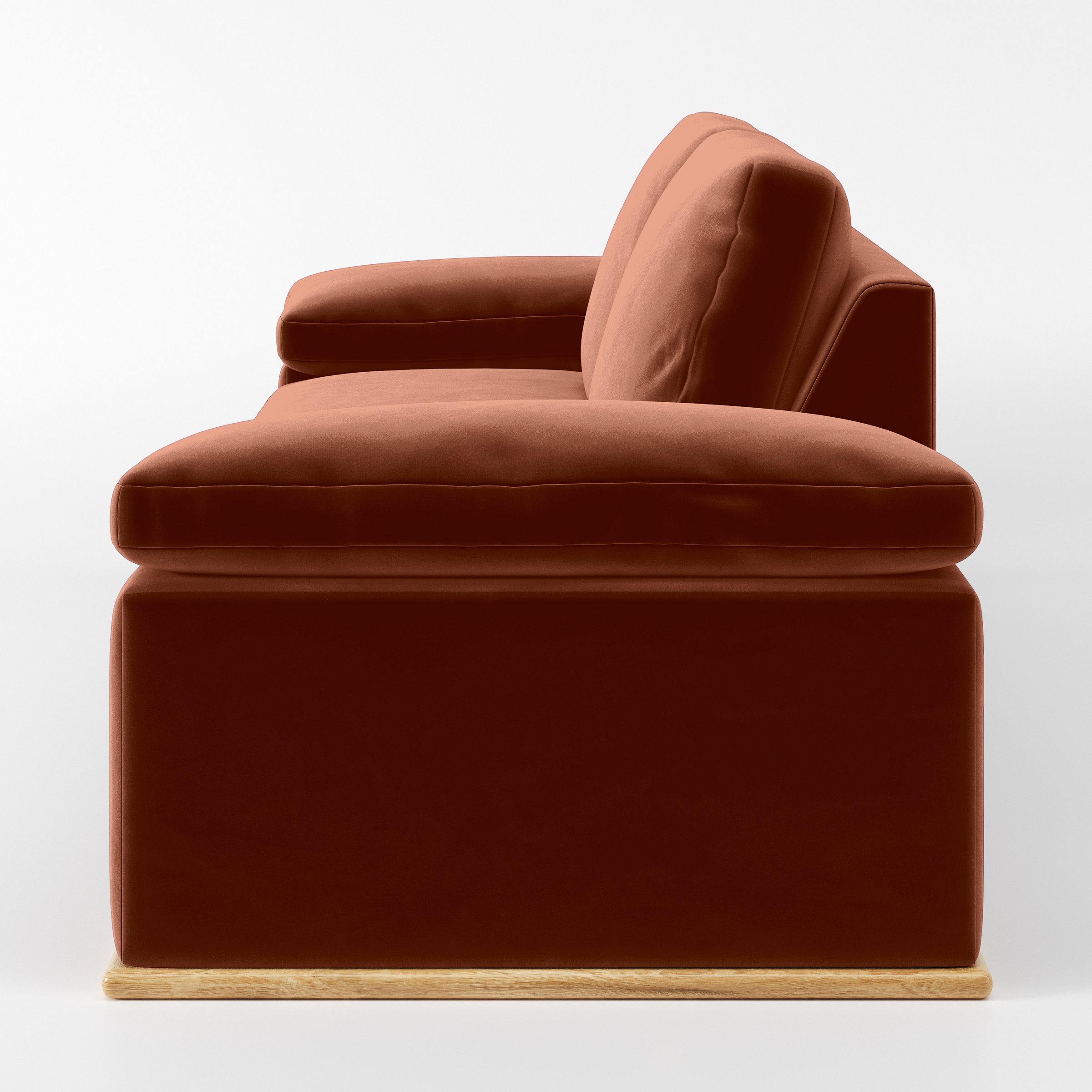 Side view of the Cusher sofa upholstered in Plush EasyClean Velvet in Apricot.