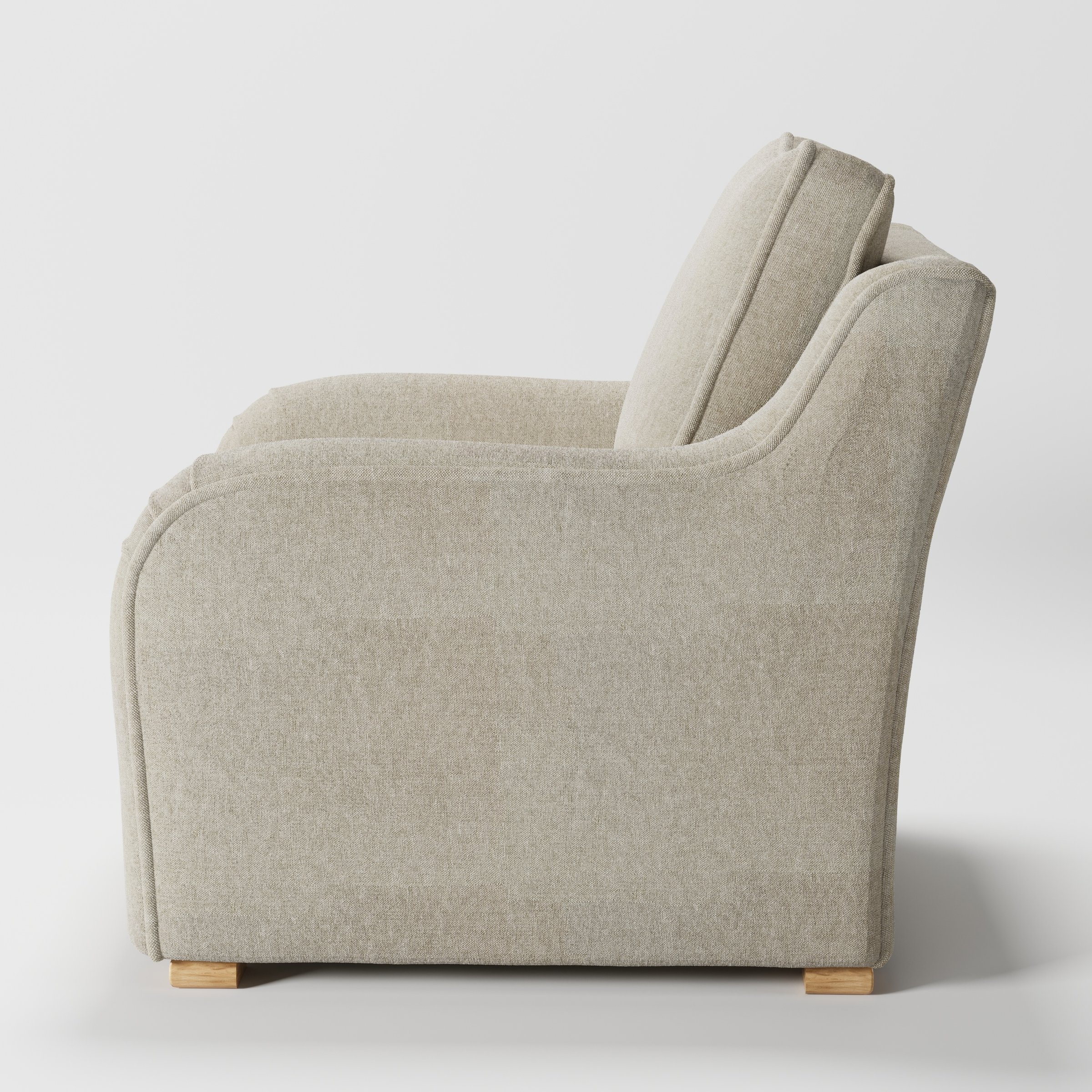 Cashel armchair in Alderney Linen Oatmeal shown in side profile displaying proportions and overall silhouette.