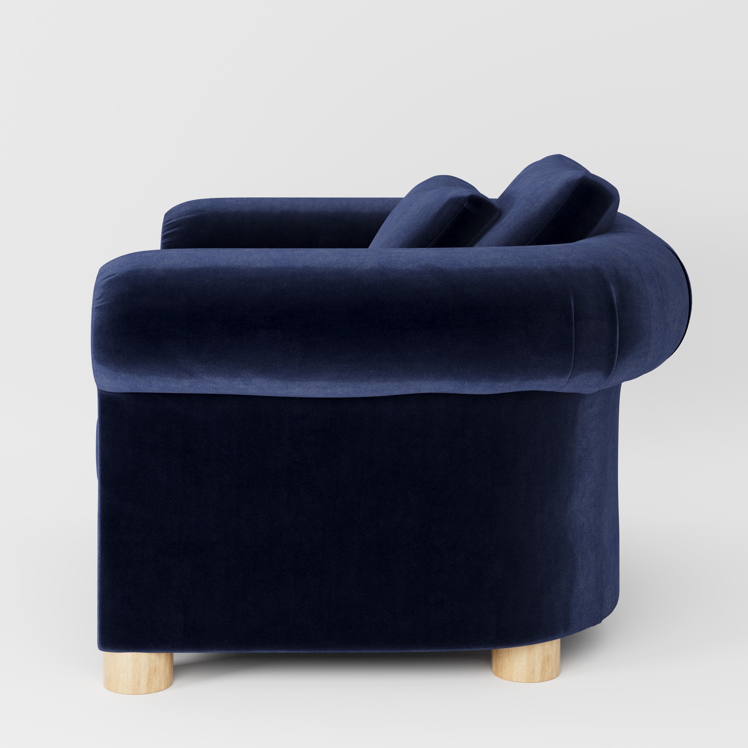 Windermere armchair in Noss Velvet Navy shown in side profile displaying proportions and overall silhouette.
