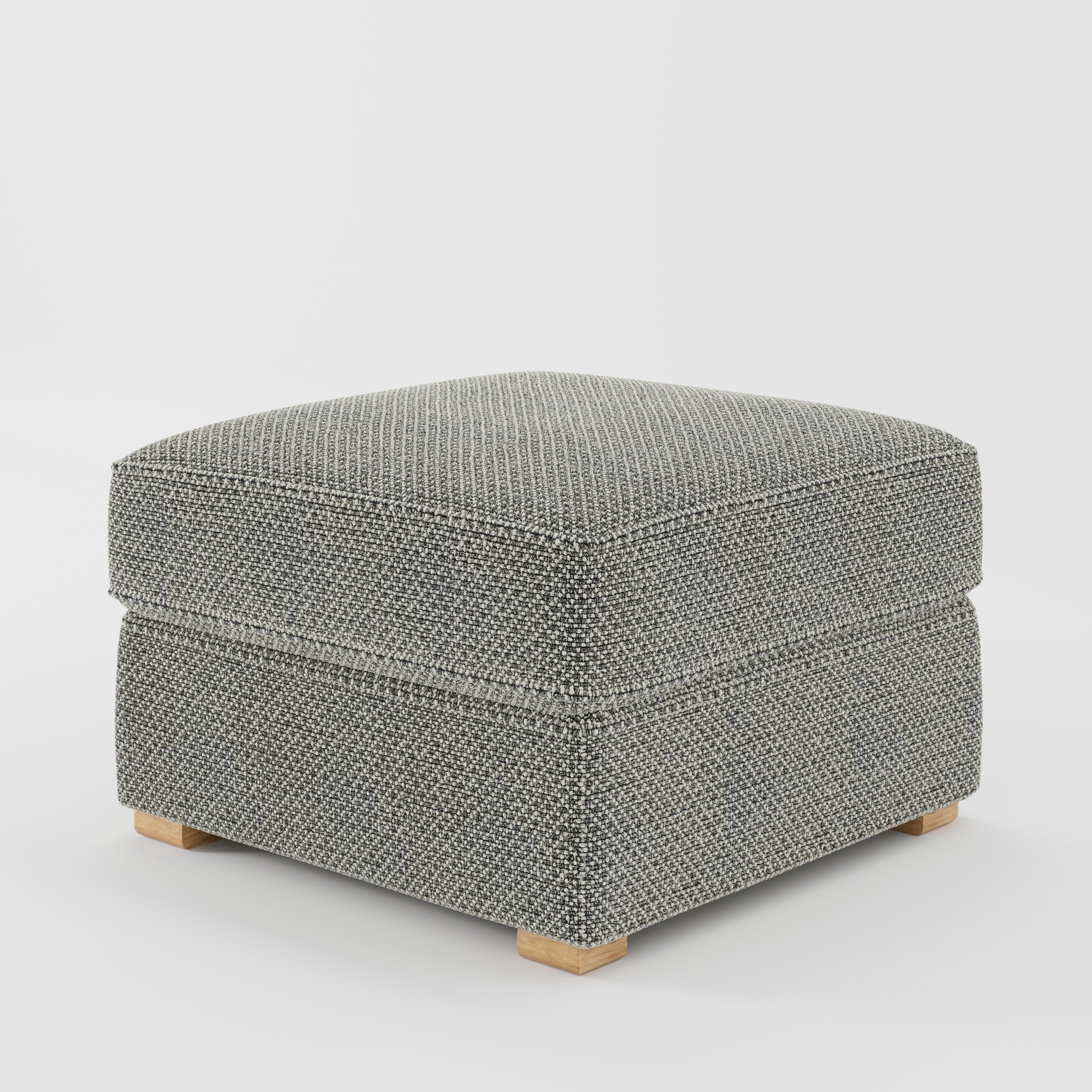 Cashel footstool in Rousay Wool Blend Tar and Chalk shown at a diagonal angle highlighting layered cushioning and low wooden feet.