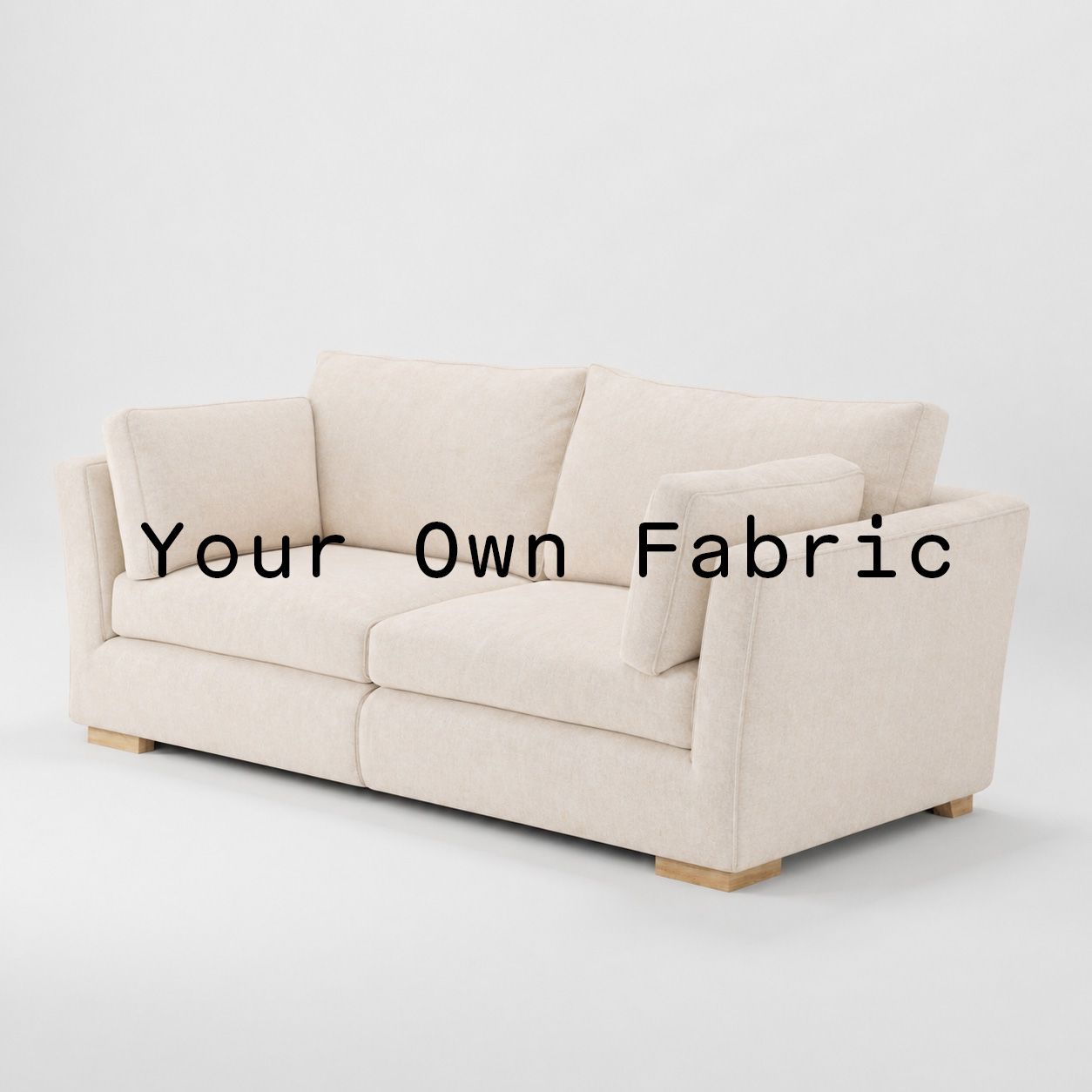 Diagonal view of the Stowe sofa upholstered in customers own material calico cotton fabric.