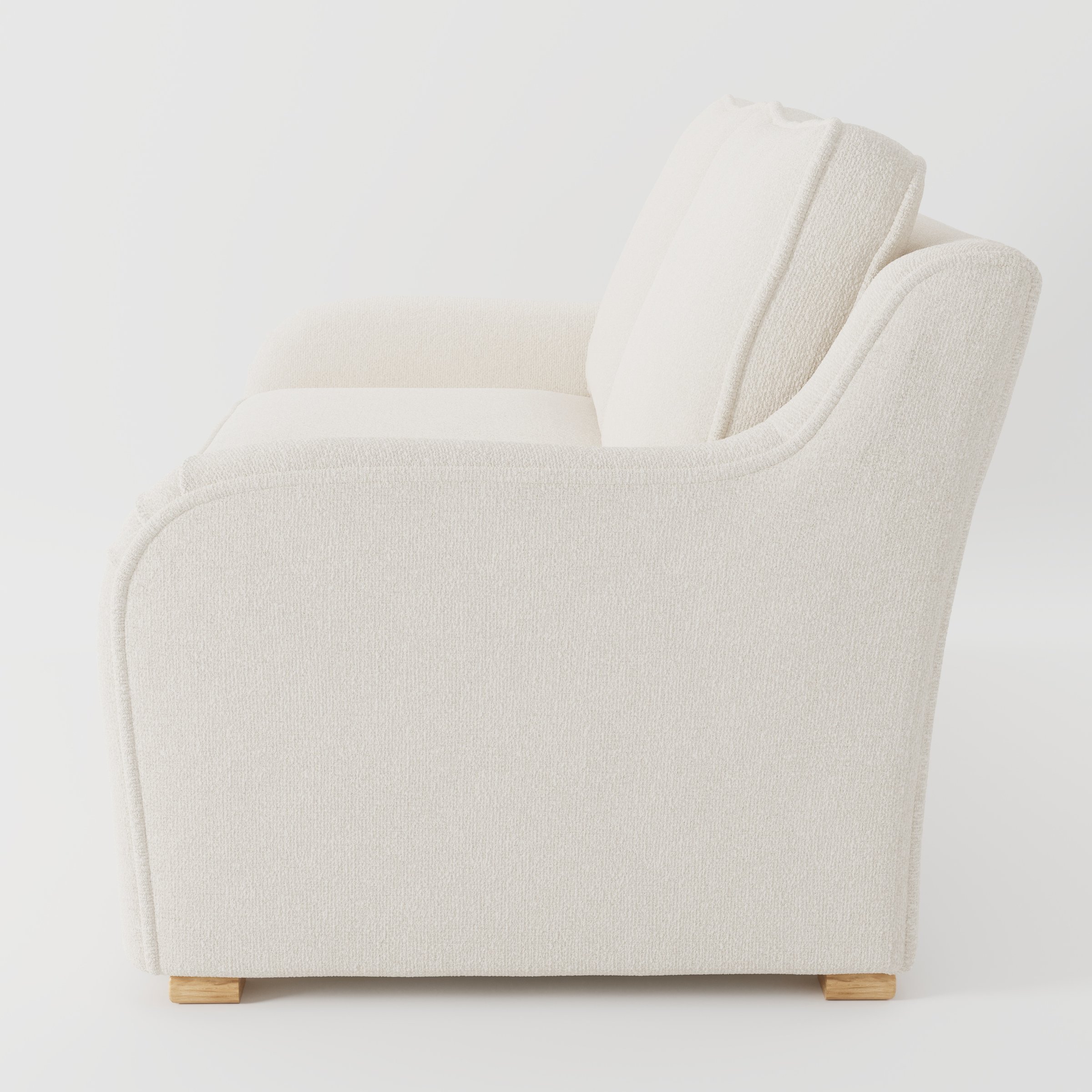 Cashel sofa in Kilda Boucle Cream shown in side profile displaying proportions and overall silhouette.