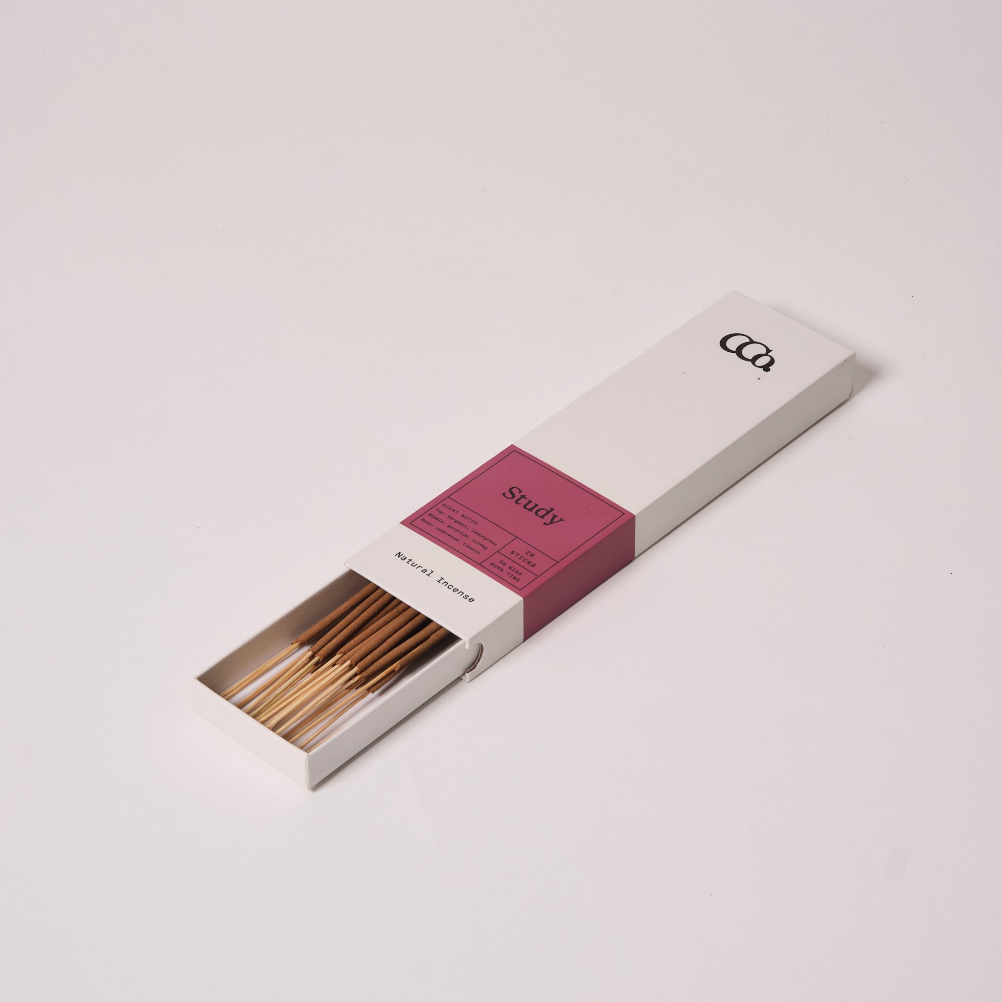 Study incense, 8 inch sticks in a minimal sliding box with muted pink label, partially open showing neatly arranged brown incense sticks with a citrus, spice, and warm wood scent profile