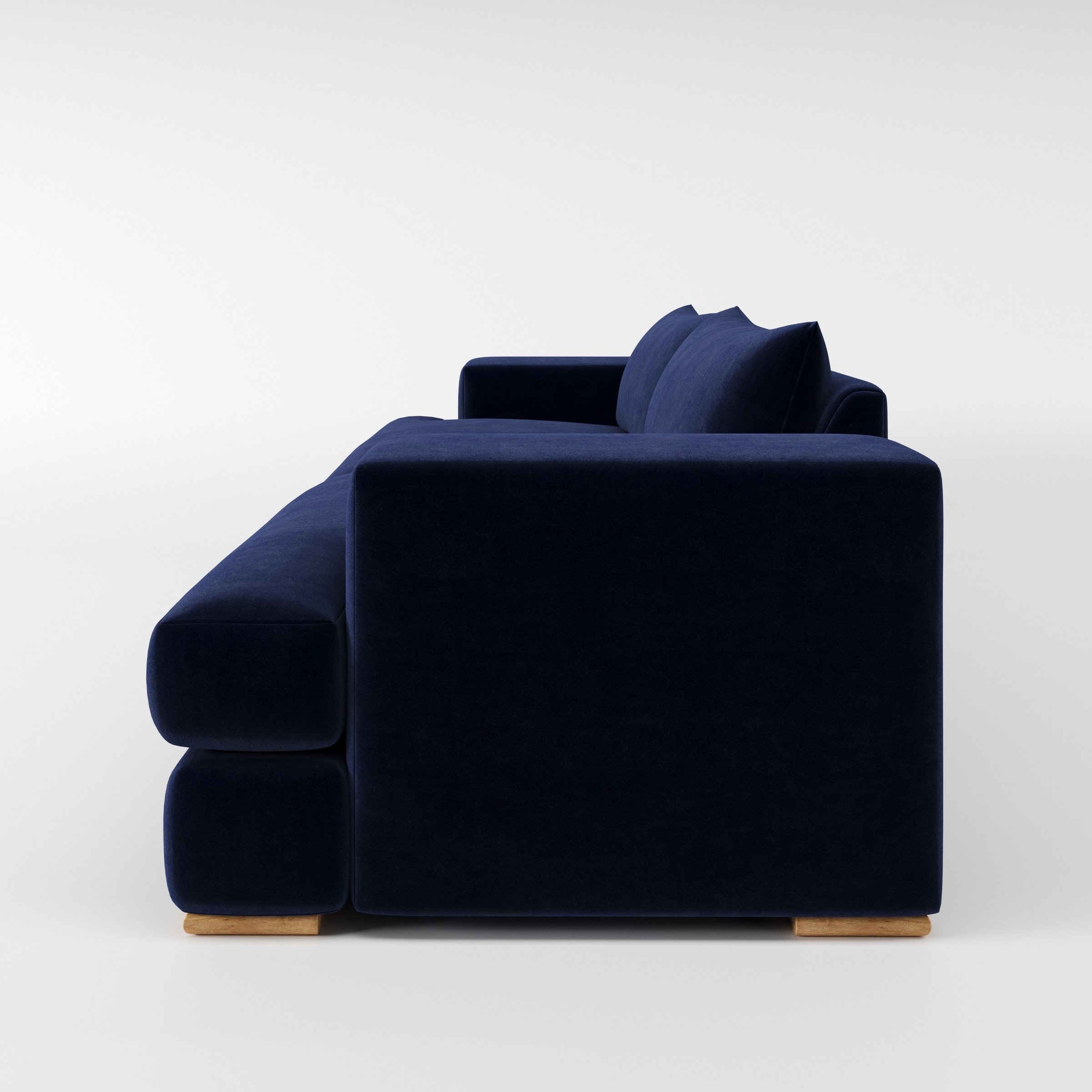 Fane sofa in Noss Velvet Navy shown in side profile displaying proportions and overall silhouette.