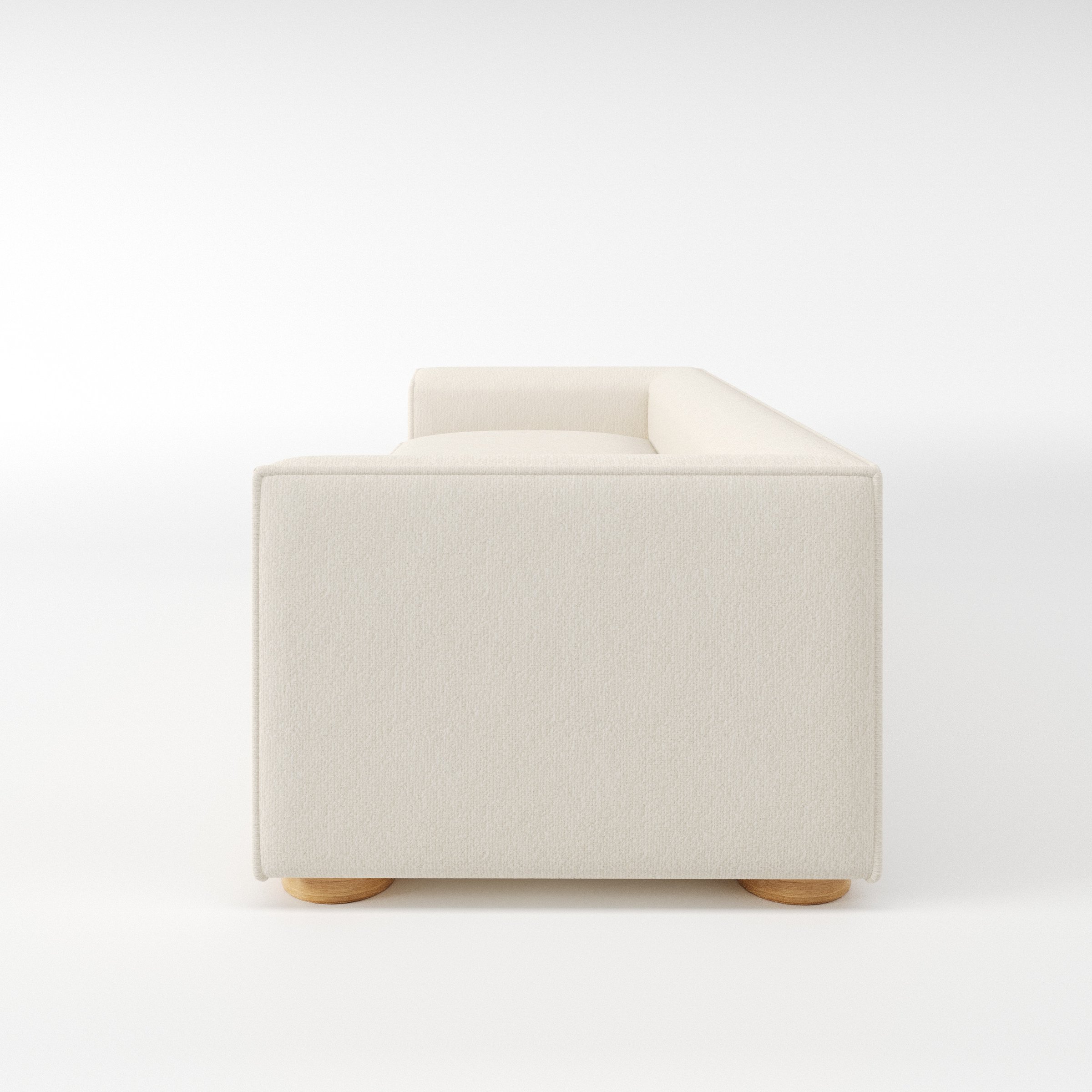 Feale sofa in Kilda Boucle Cream shown in side profile displaying proportions and overall silhouette.