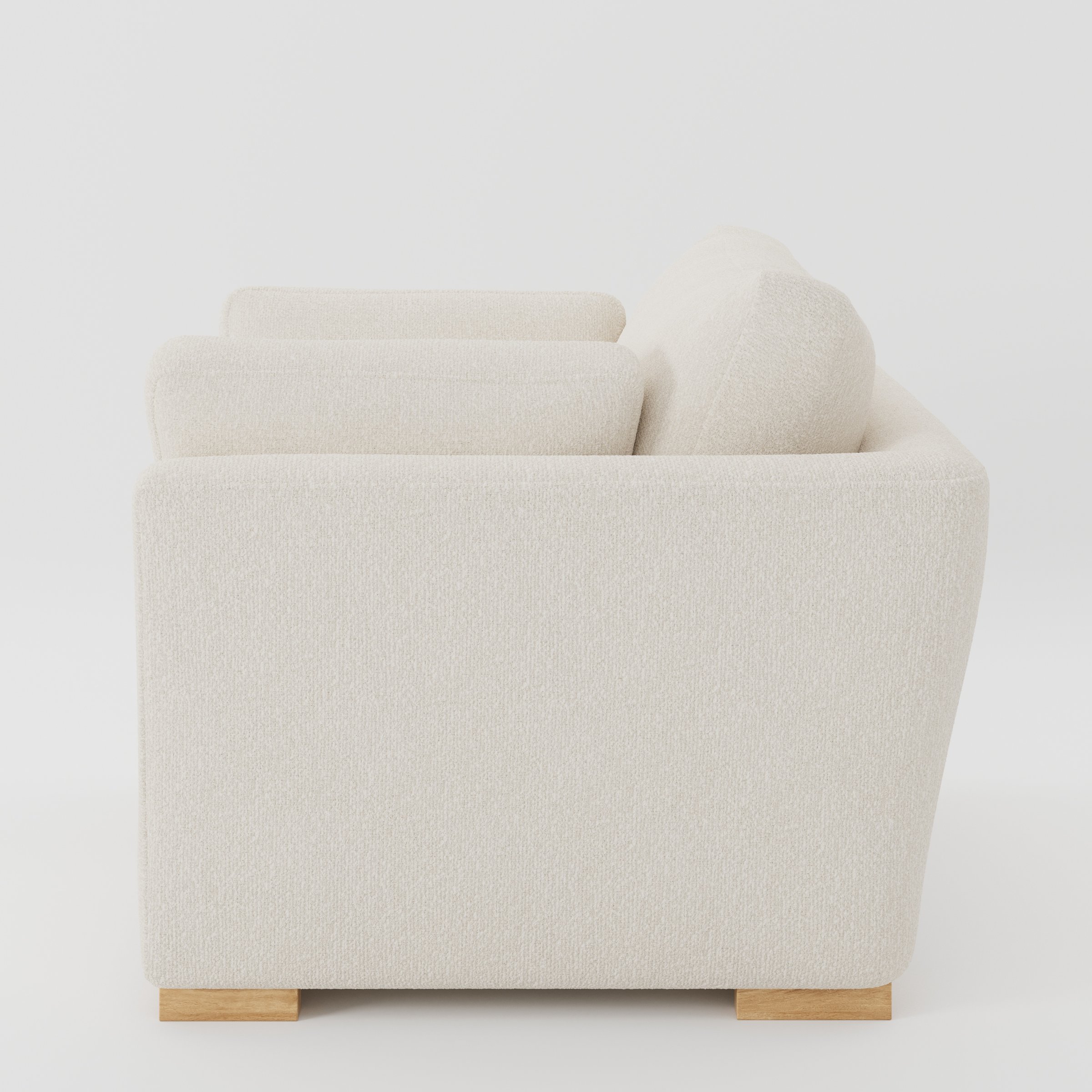Stowe armchair in Kilda Boucle Cream shown in side profile displaying proportions and overall silhouette.