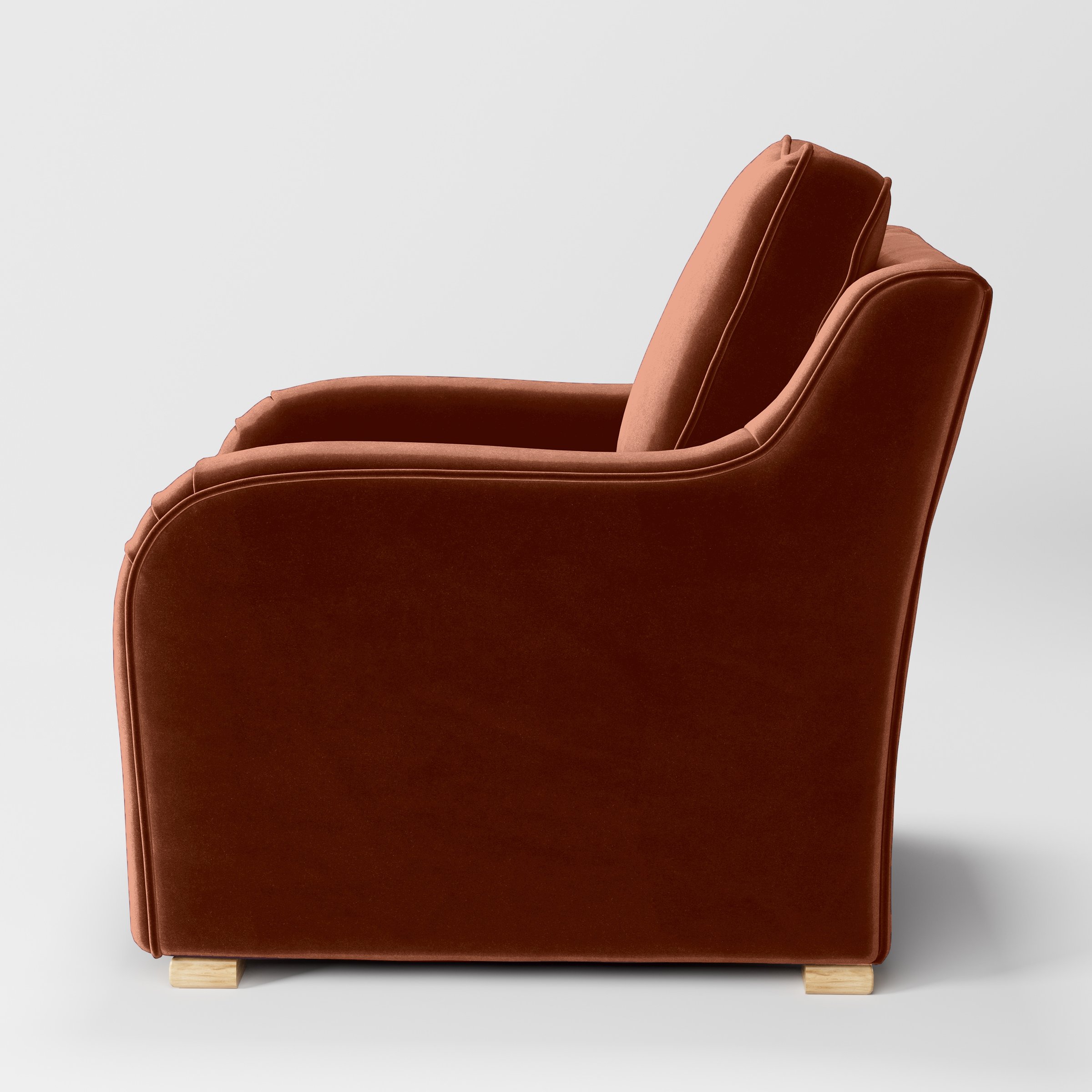 Side view of the Cashel armchair upholstered in Plush EasyClean Velvet in Apricot.