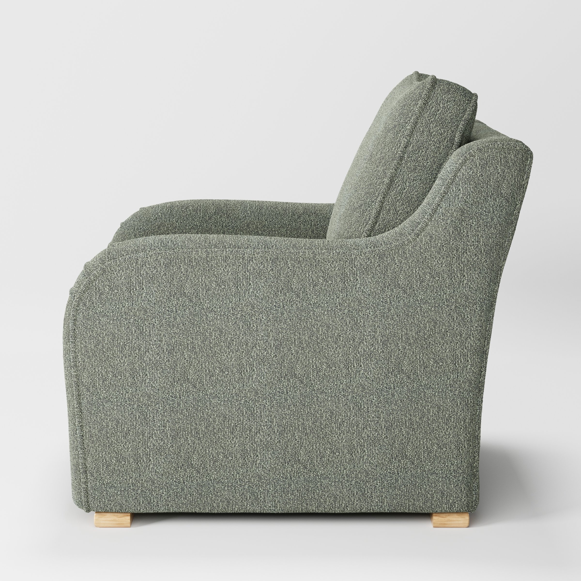 Cashel armchair in Kilda Boucle Moss shown in side profile displaying proportions and overall silhouette.