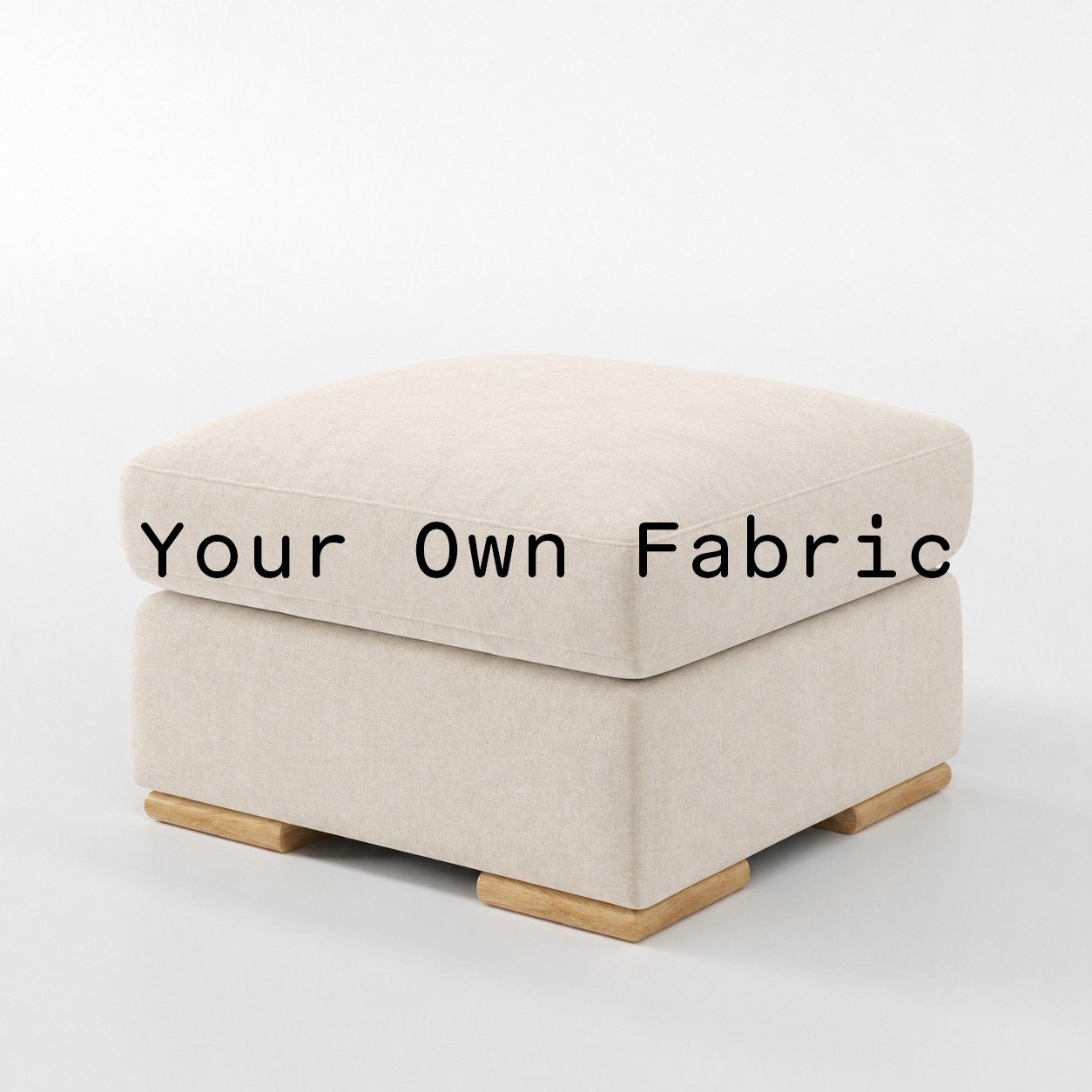 Diagonal view of the Moy footstool upholstered in customers own material calico cotton fabric.